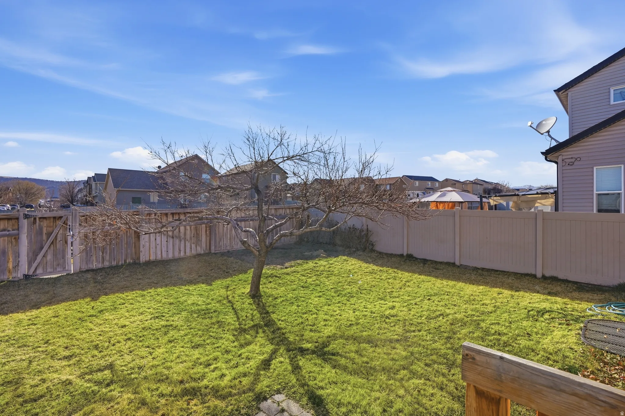 Fenced backyard featuring a residential view
