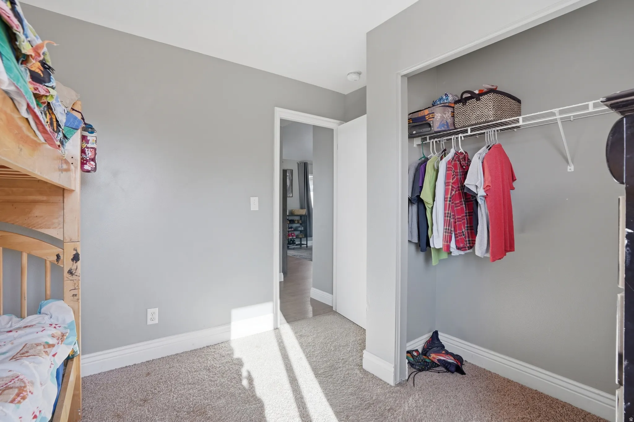 Bedroom featuring light colored carpet and a closet