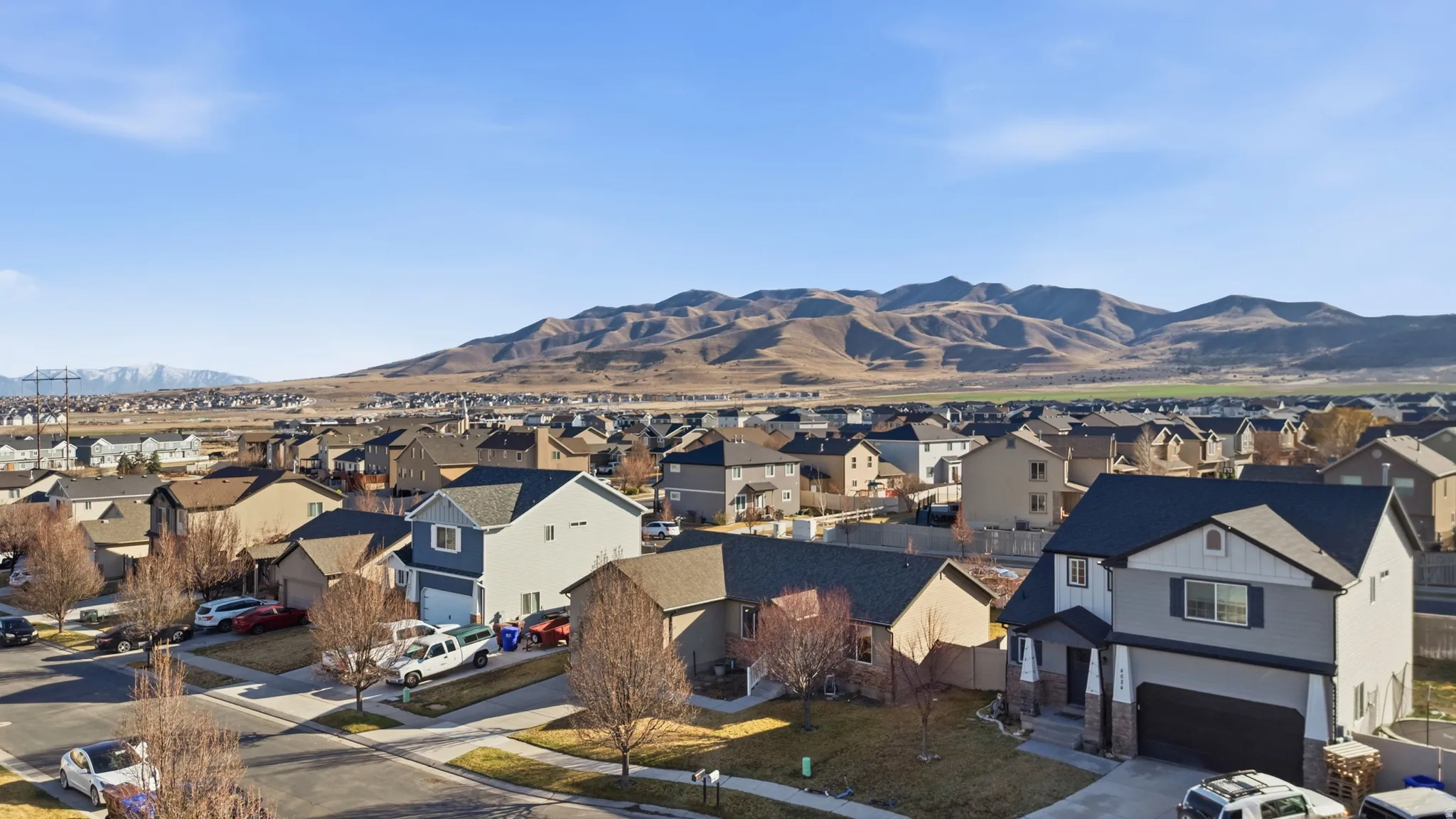 View of mountain backdrop featuring nearby suburban area