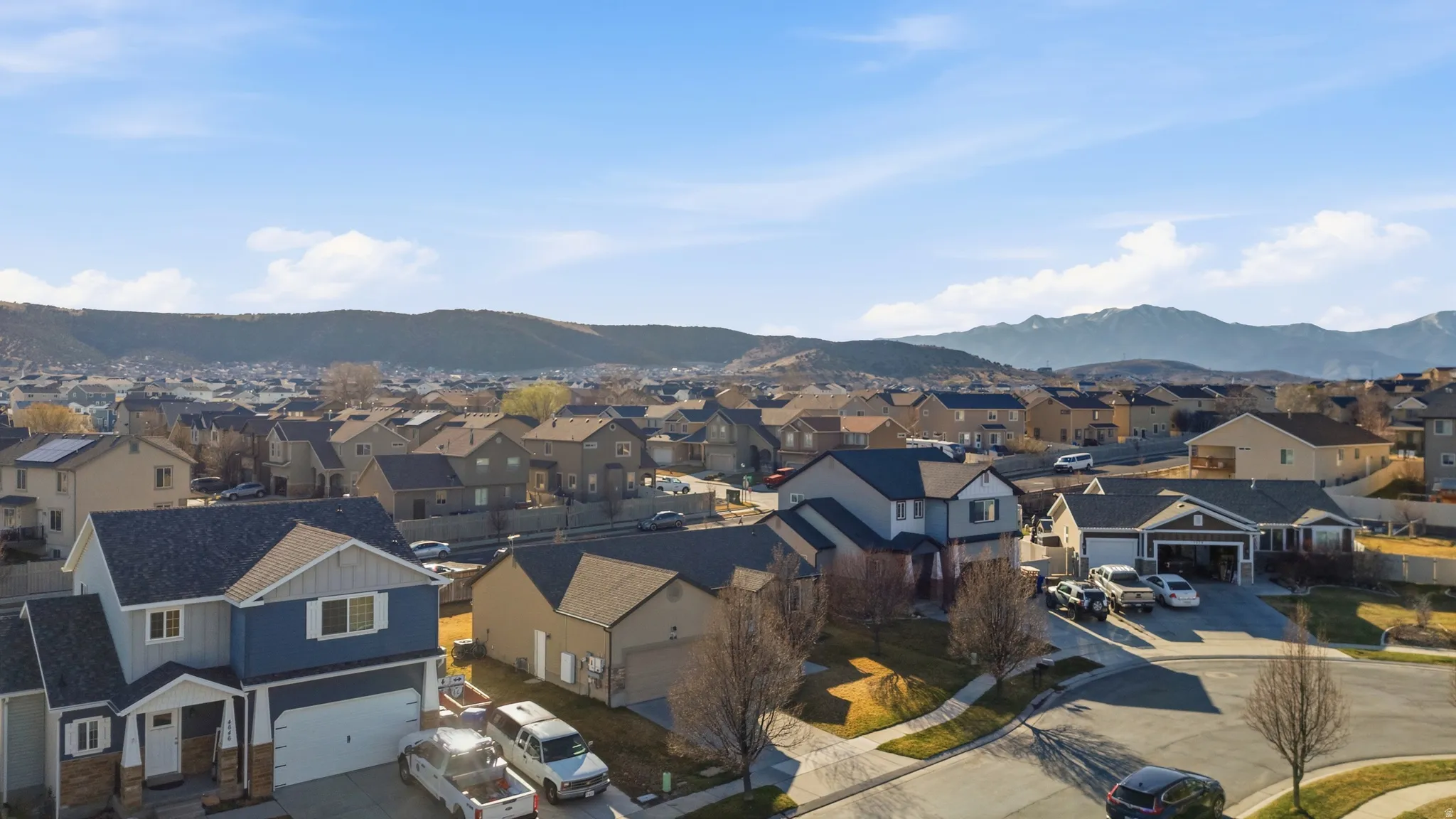 Aerial perspective of suburban area featuring a mountainous background