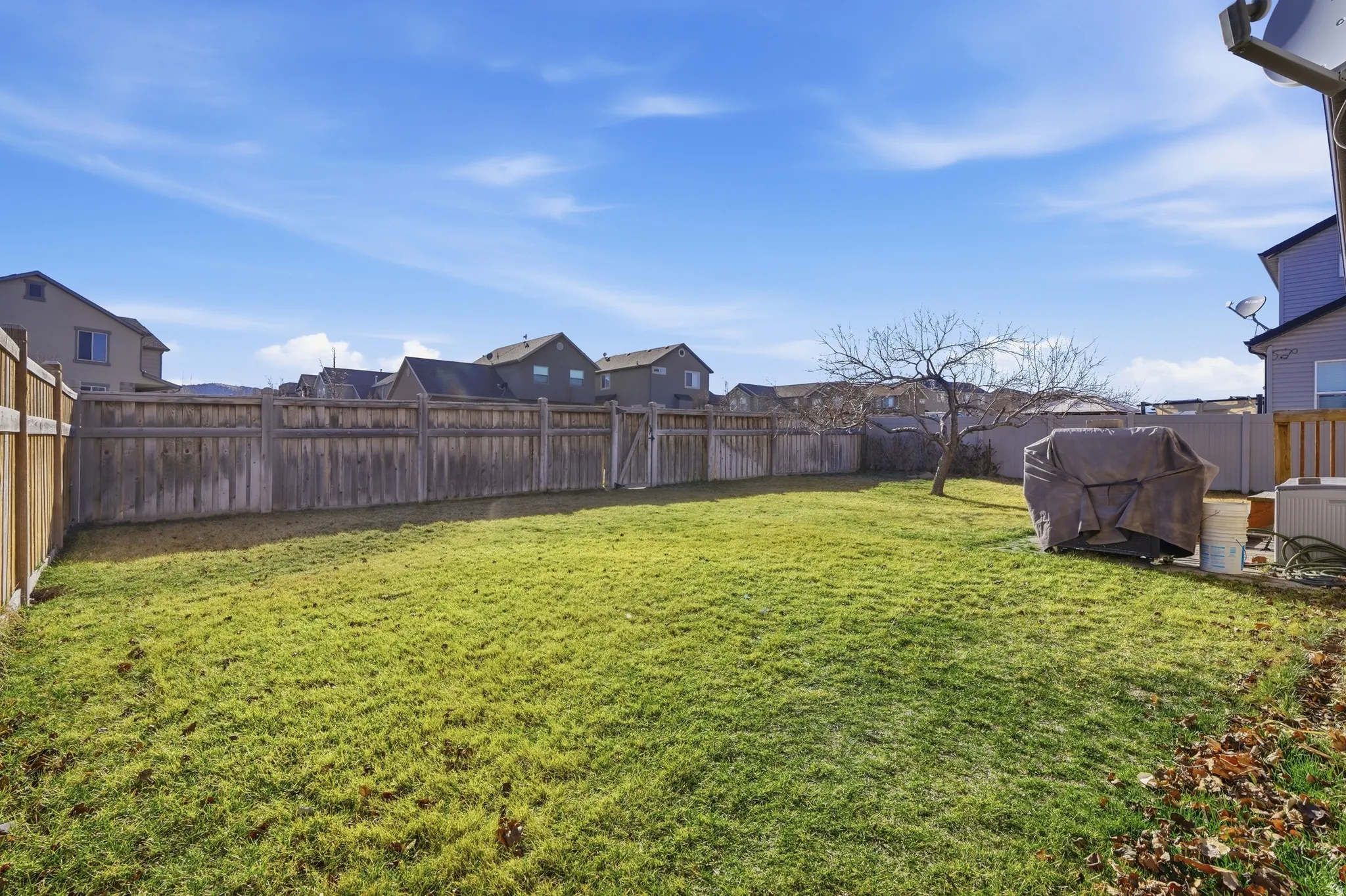 Fenced backyard featuring a residential view