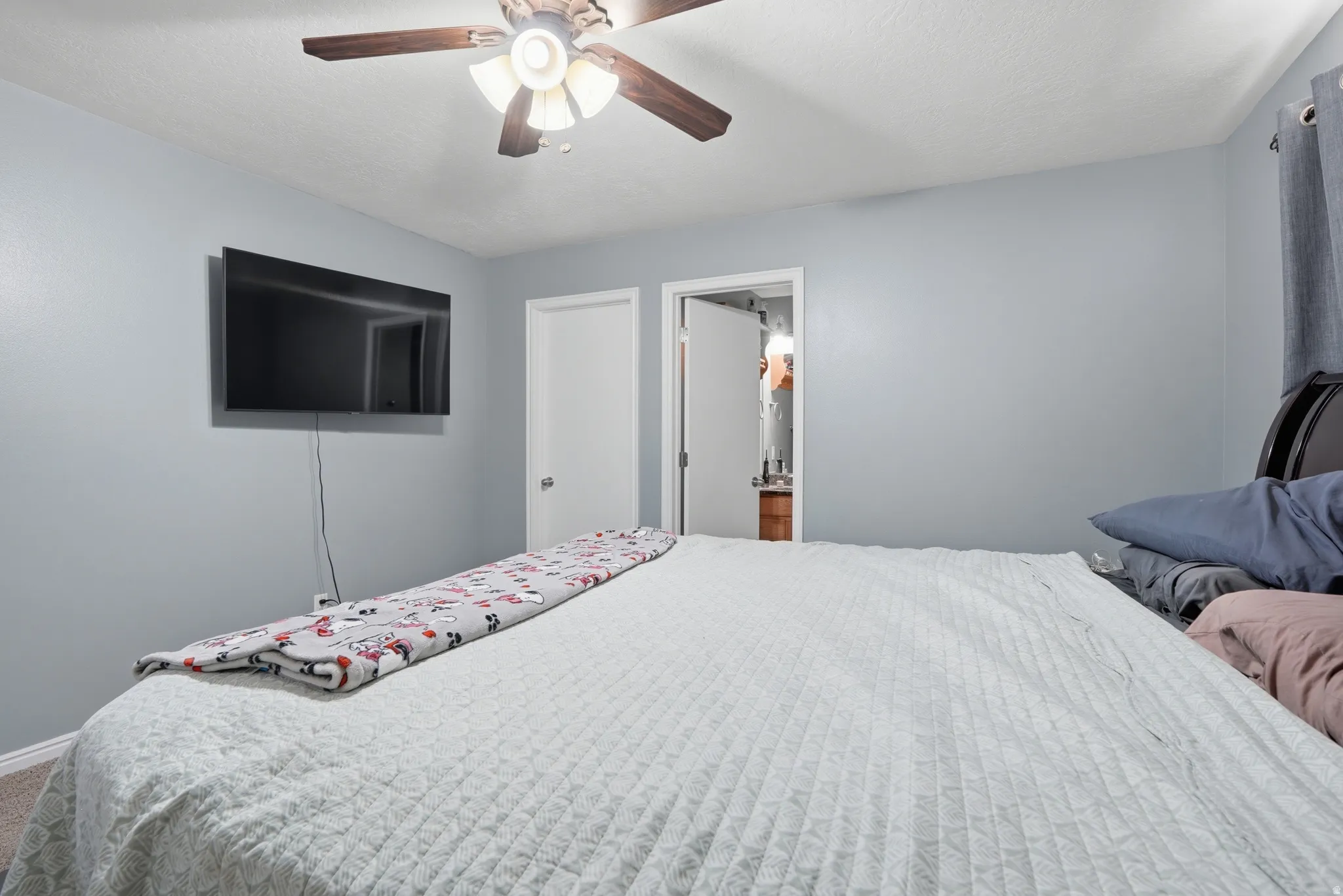 Bedroom featuring ceiling fan and carpet flooring
