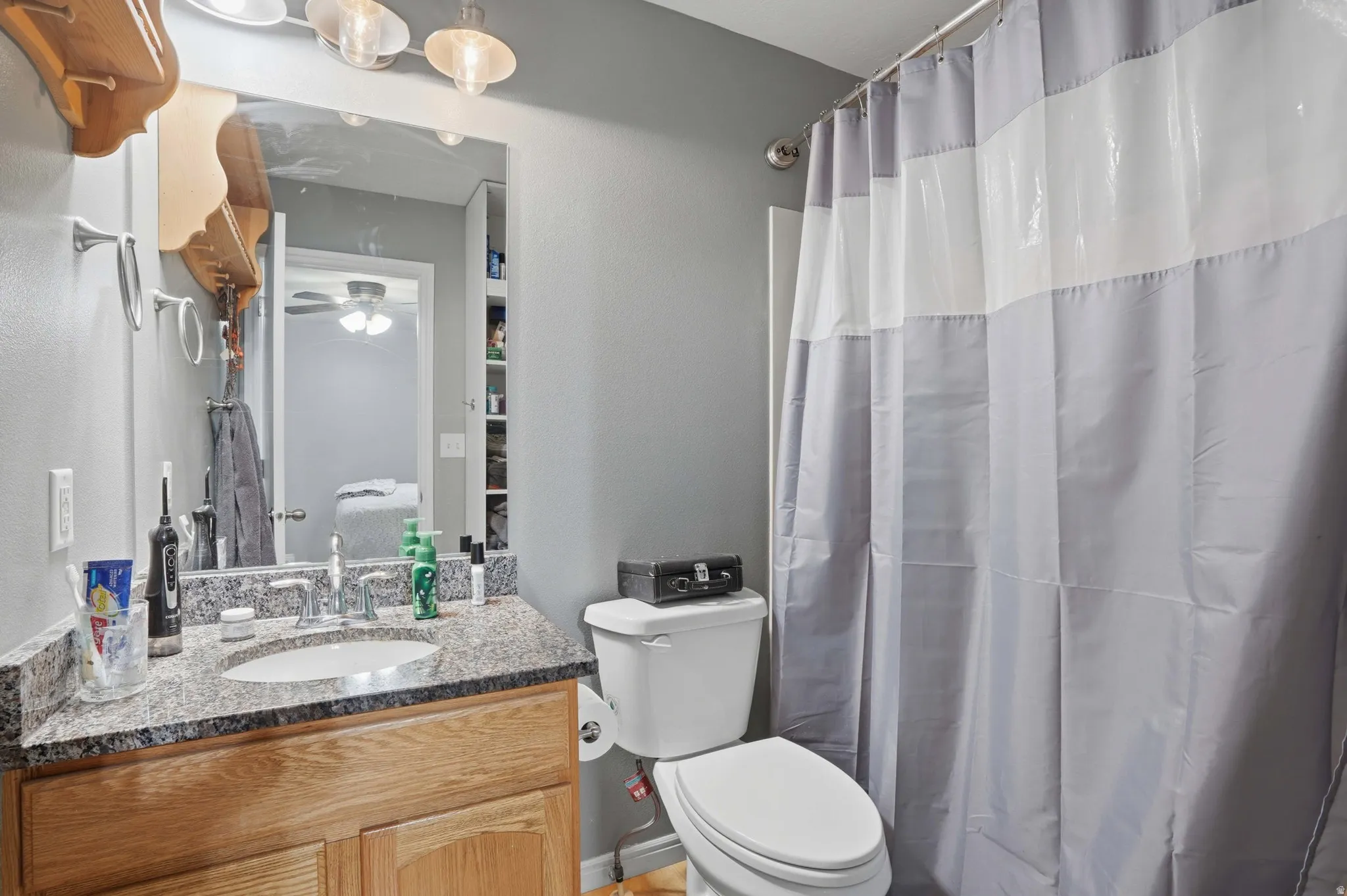 Bathroom with vanity and curtained shower