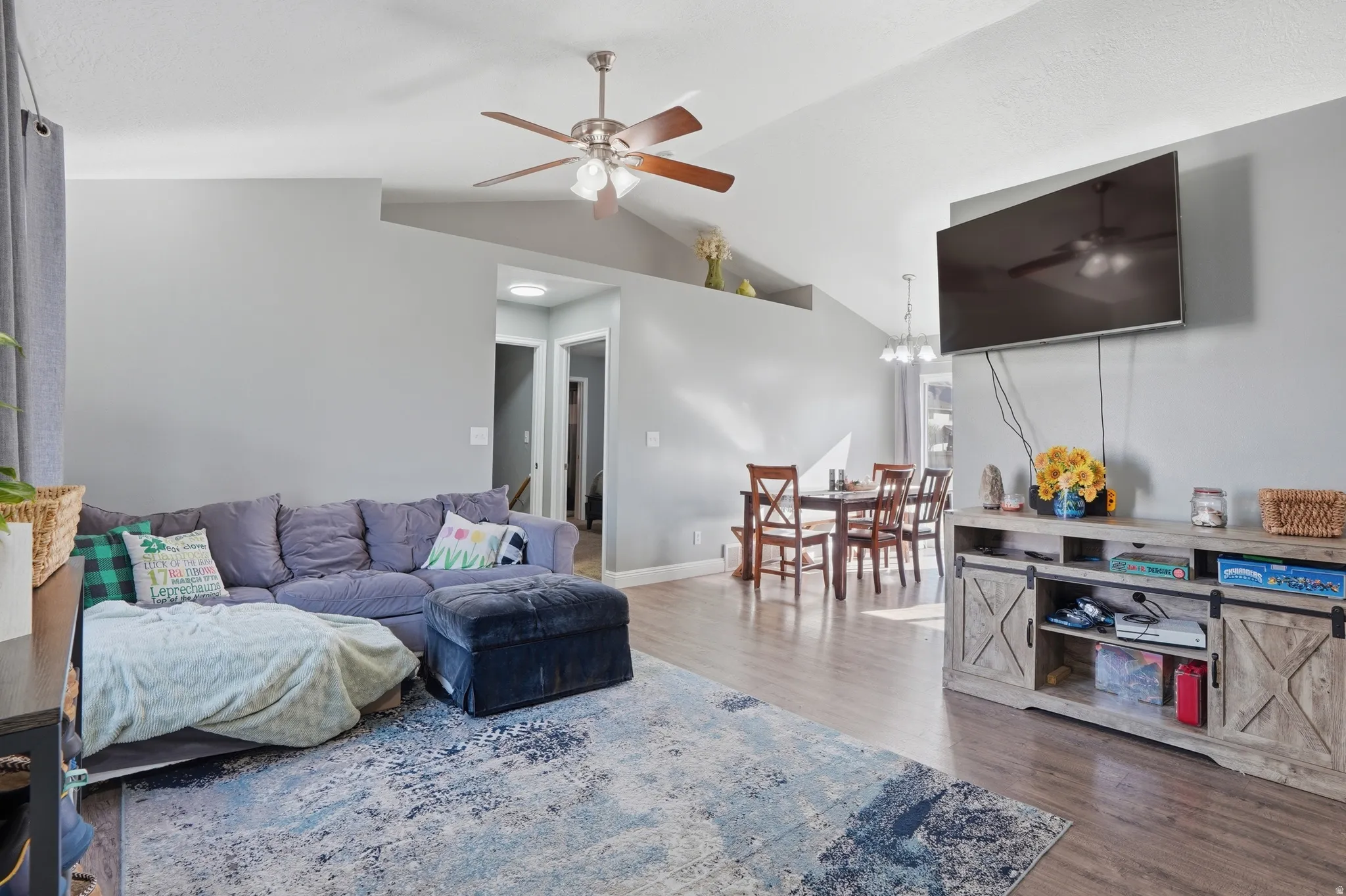 Living room featuring ceiling fan and dark wood finished floors