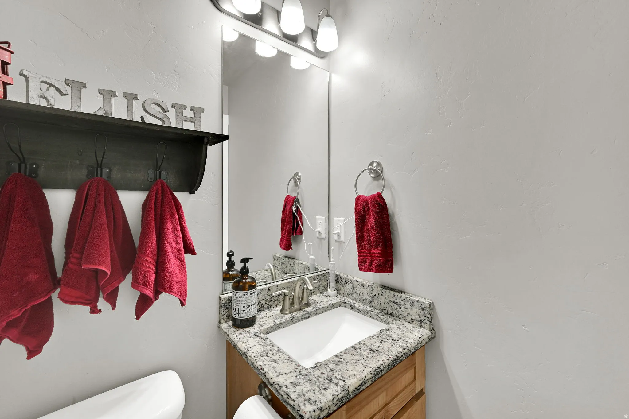 Bathroom with vanity and a textured wall