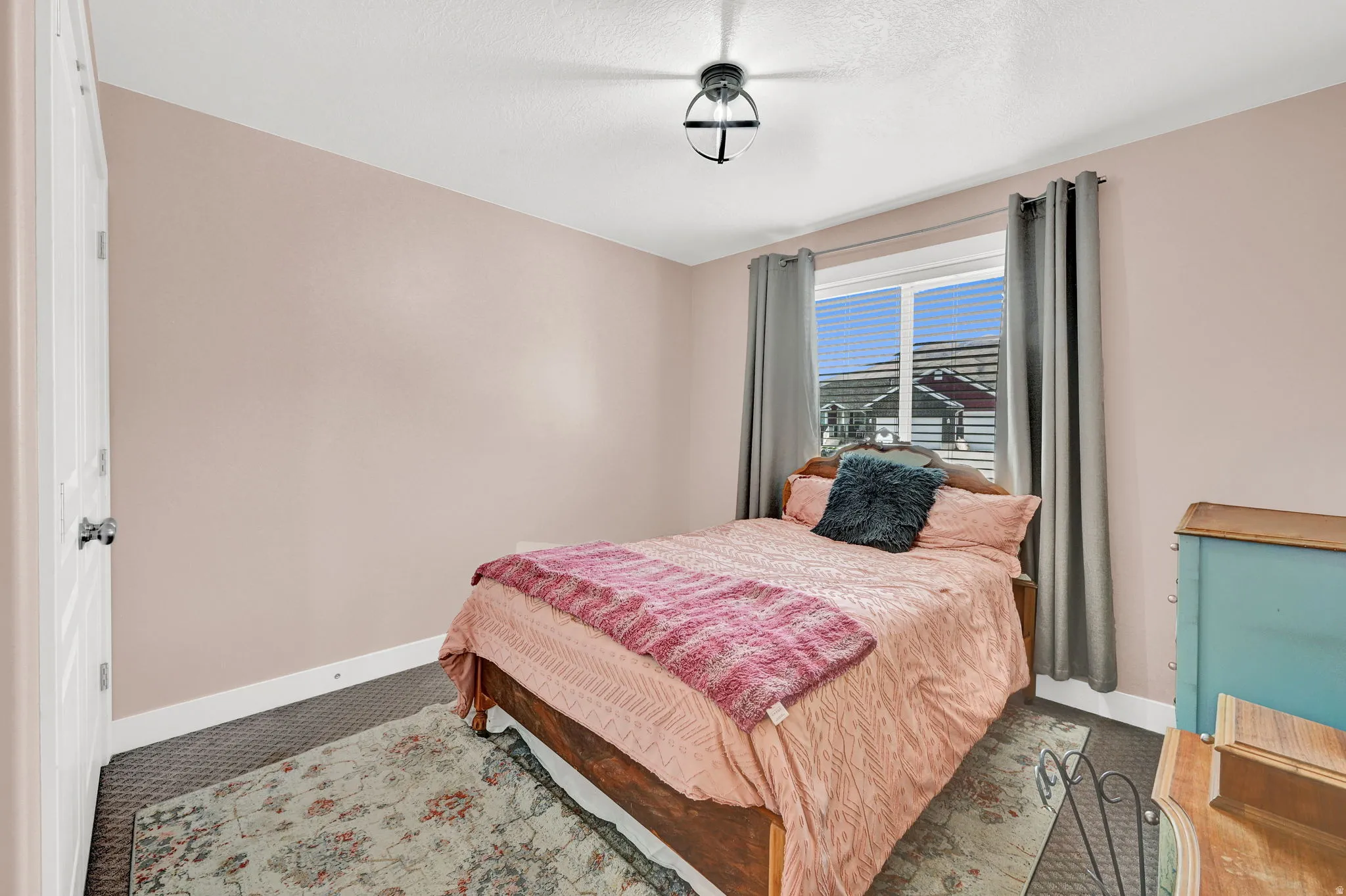 Carpeted bedroom featuring baseboards