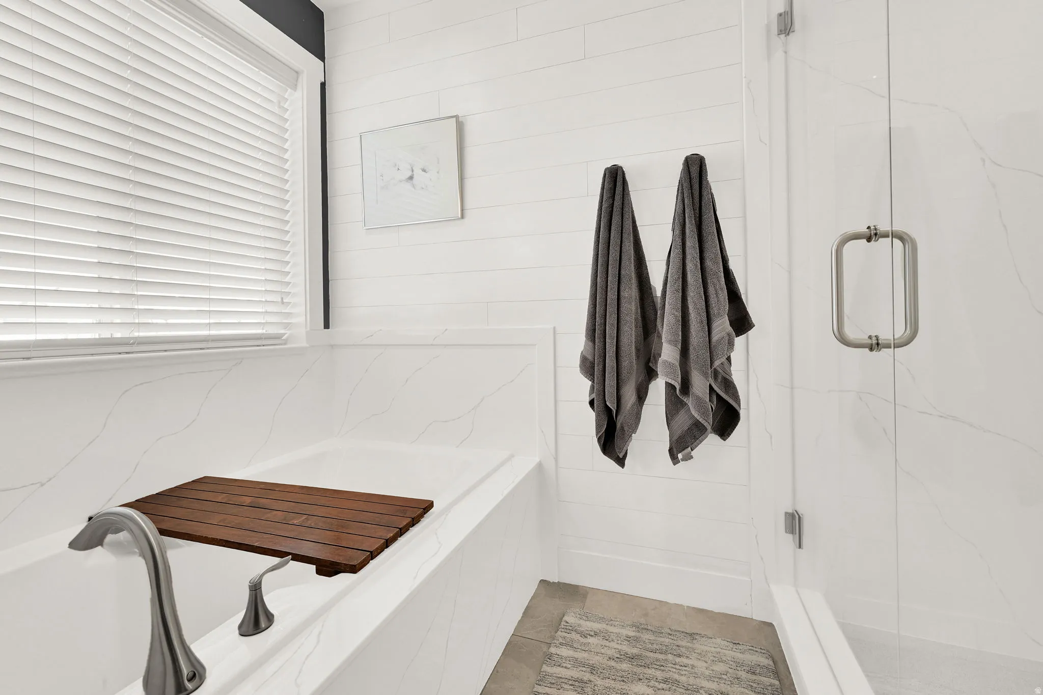 Full bathroom featuring a marble finish shower and a garden tub