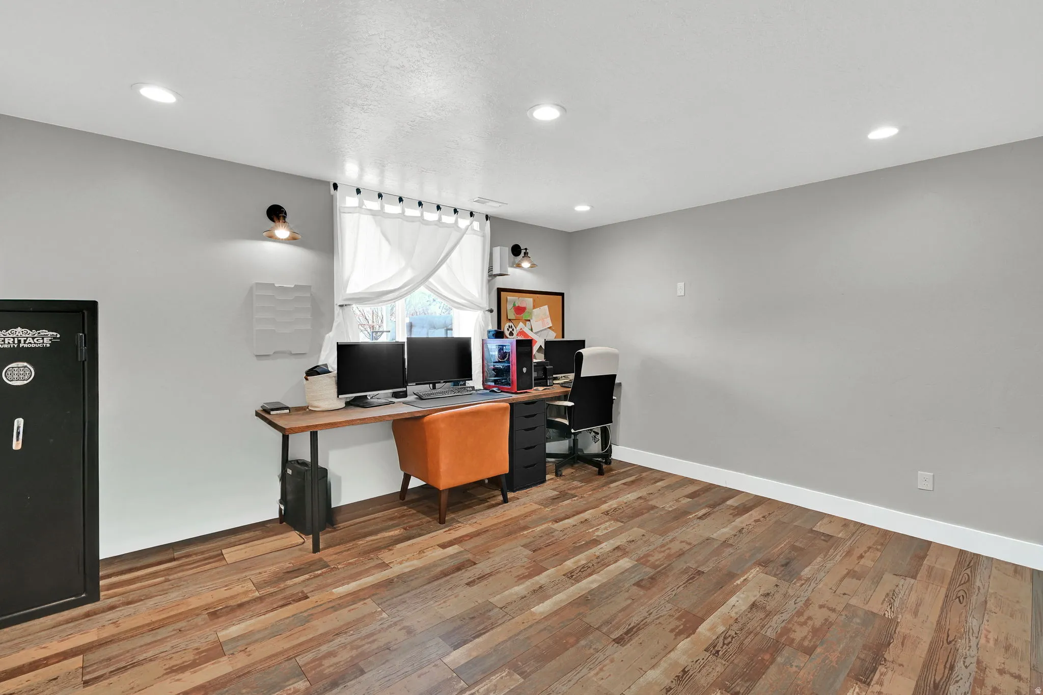 Office space featuring light wood-type flooring and recessed lighting