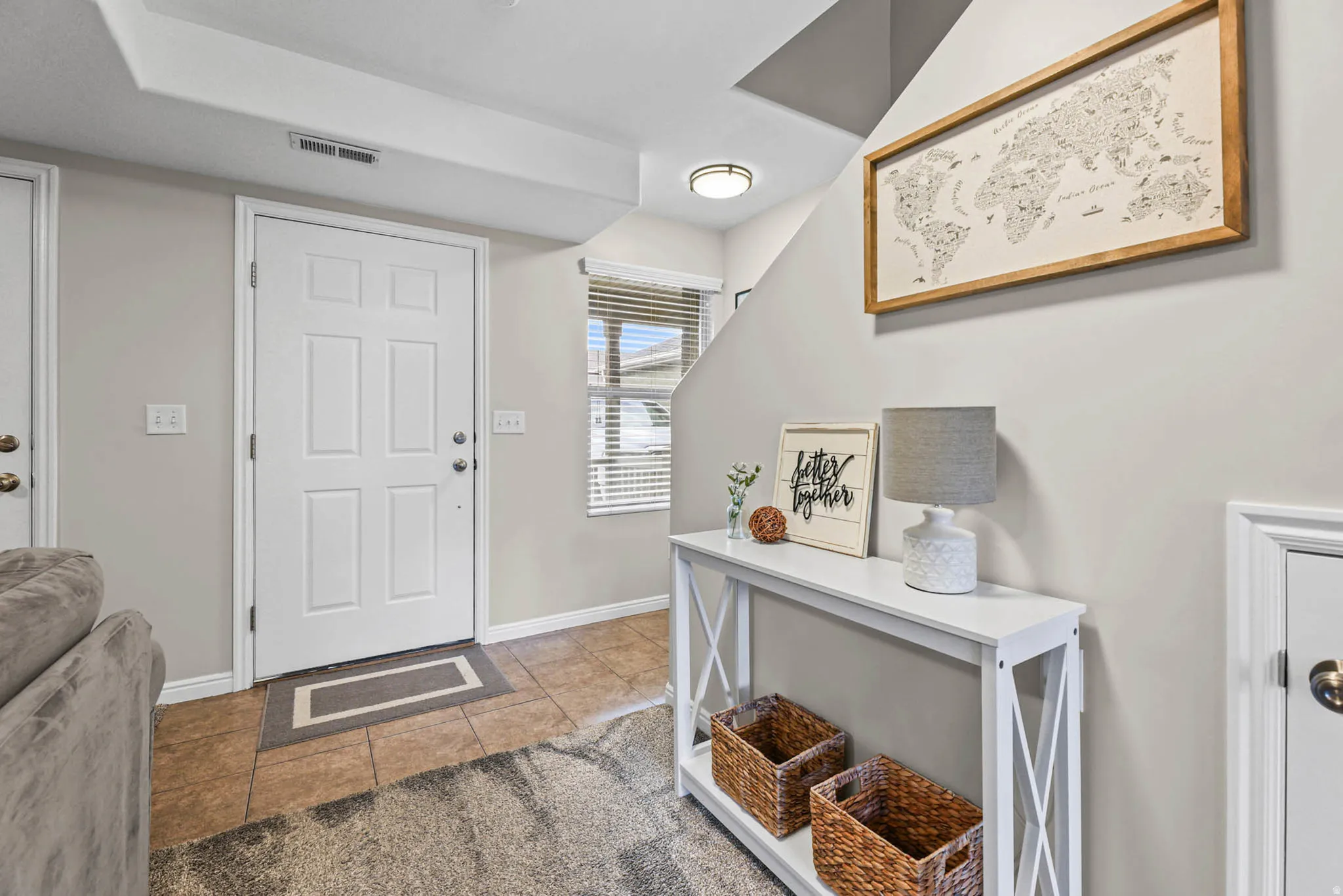 Foyer featuring light tile patterned flooring and baseboards