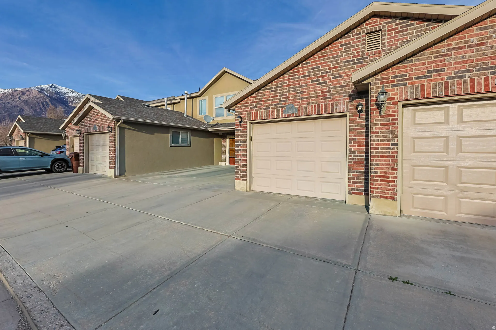 View of home's exterior with brick siding and a mountain view