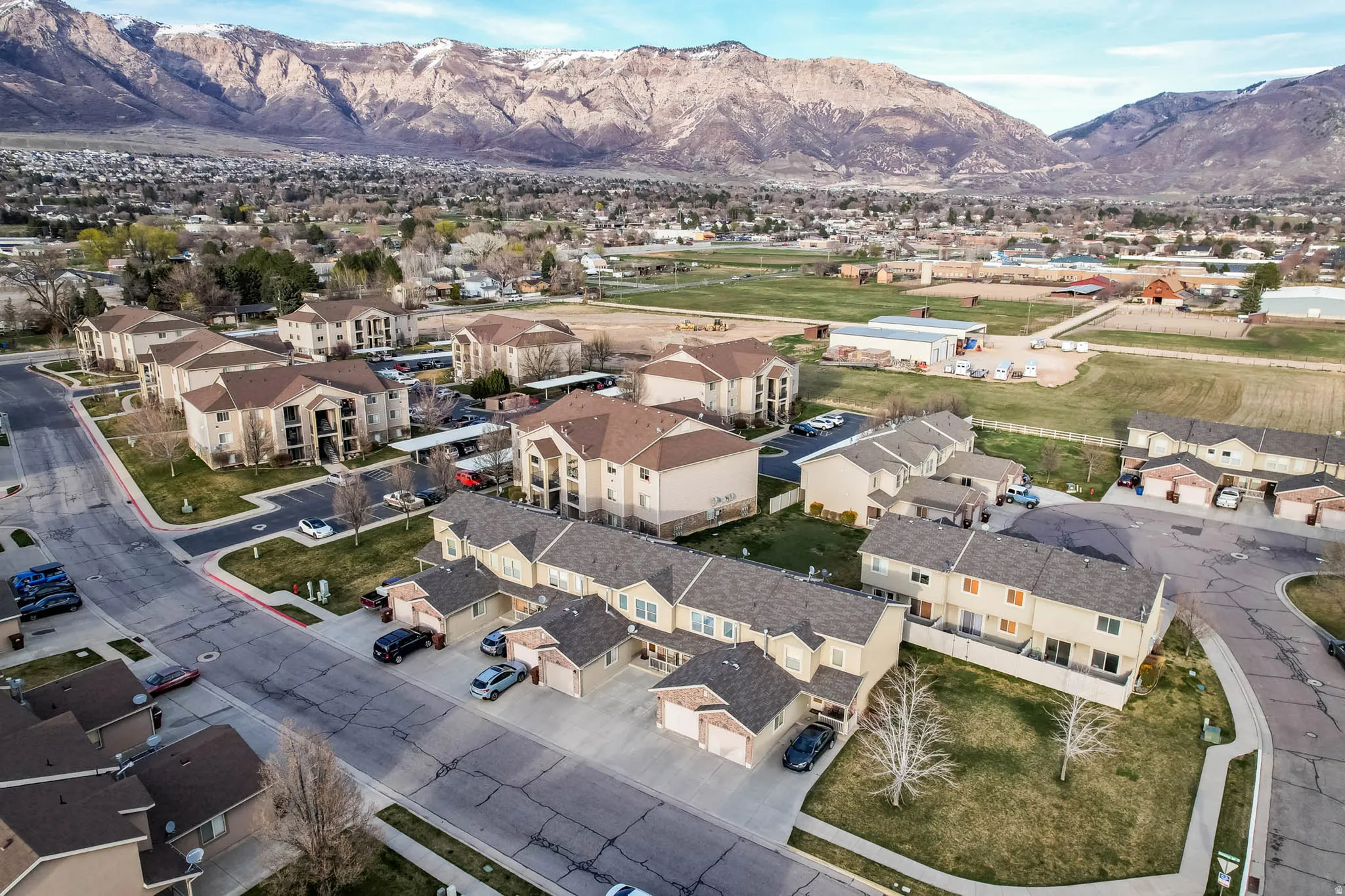Aerial view of property's location with a mountain backdrop and nearby suburban area