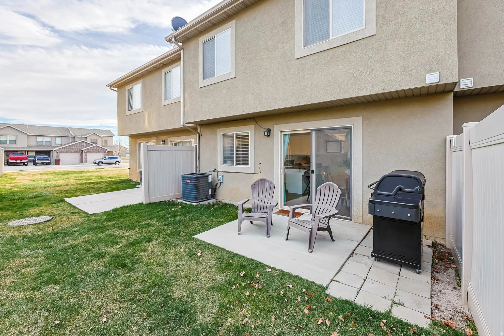Back of property featuring stucco siding and a patio