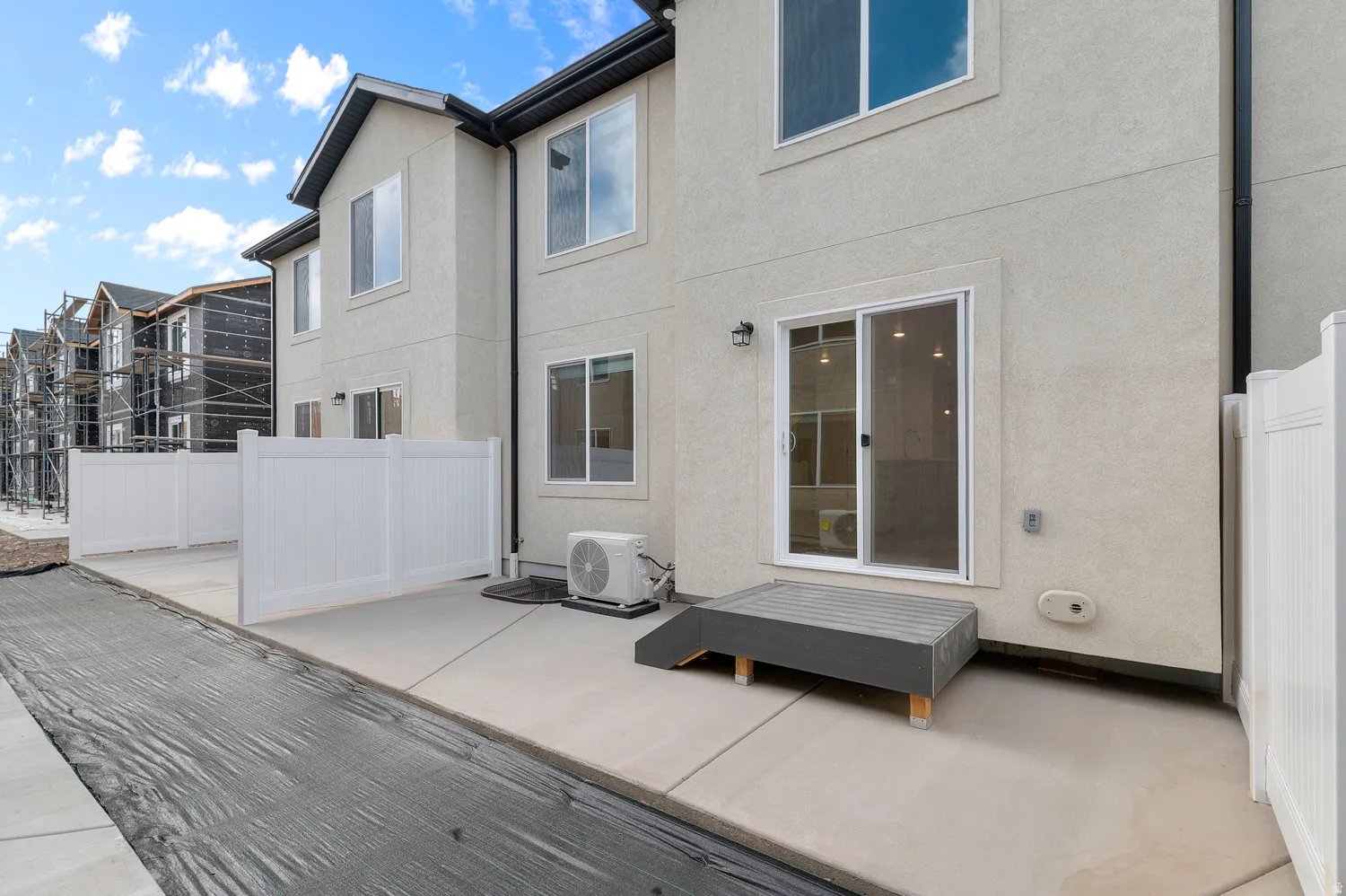 Rear view of house featuring stucco siding