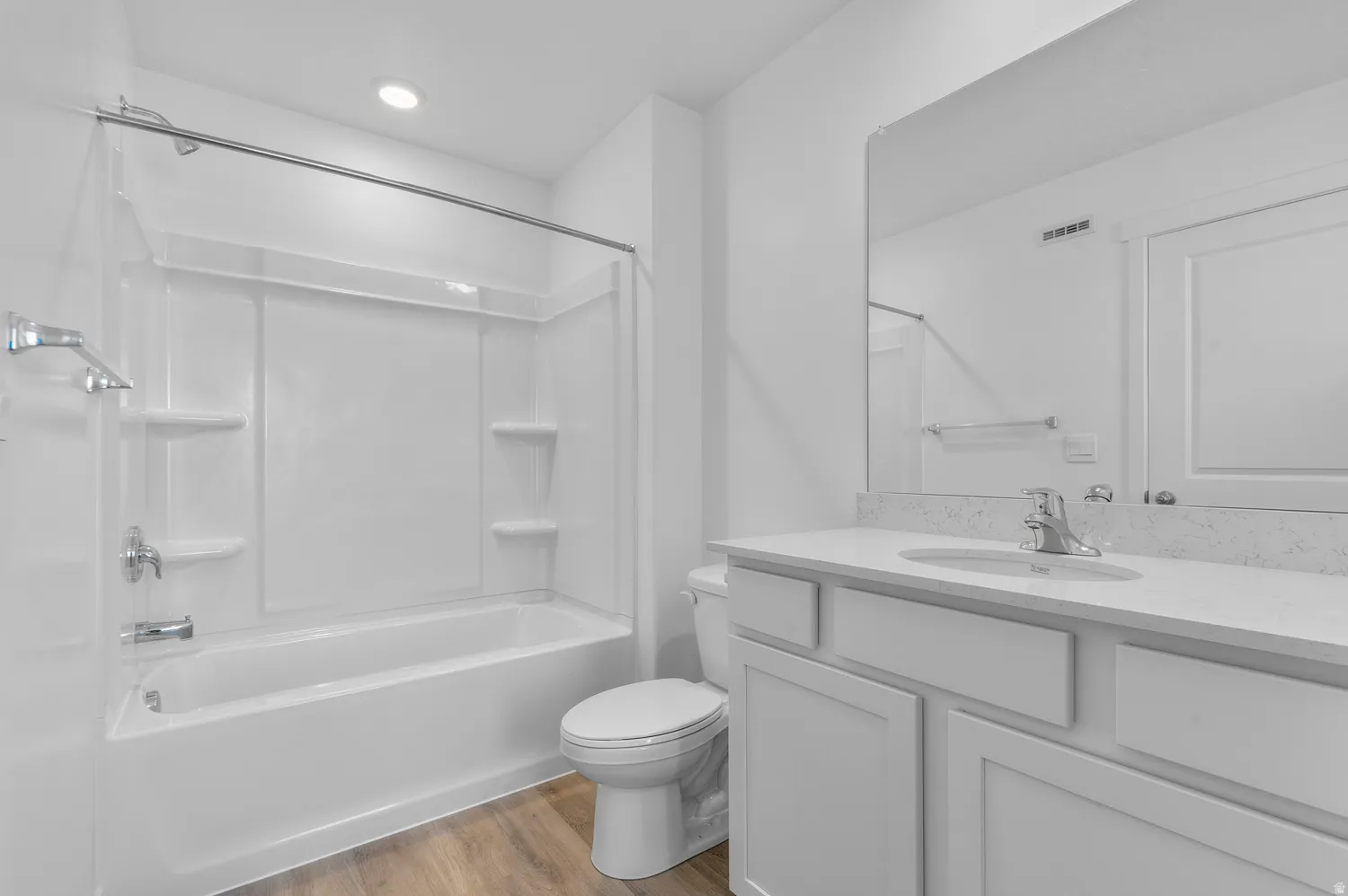 Full bath featuring vanity, dark wood-style flooring, and  shower combination