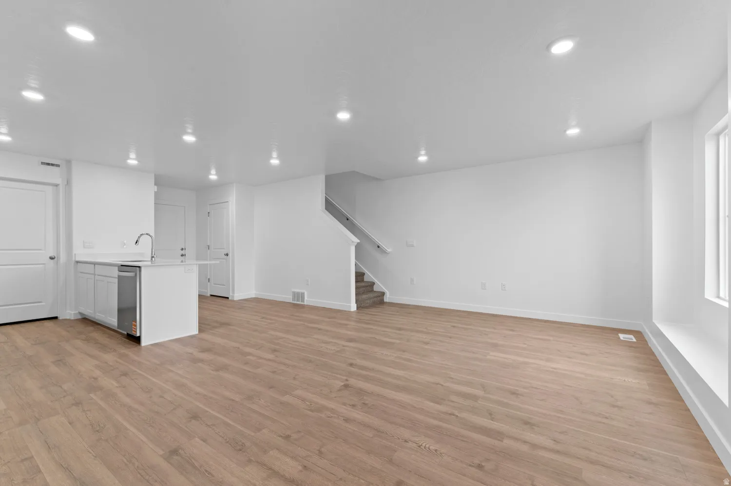 Unfurnished living room featuring light wood-style floors and recessed lighting