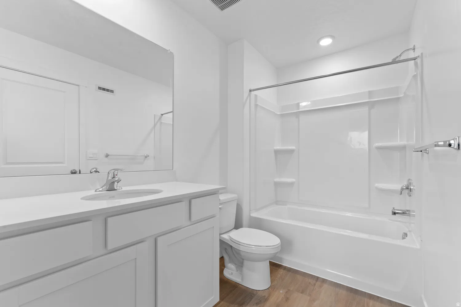 Full bath featuring vanity, dark wood-style flooring, and  shower combination