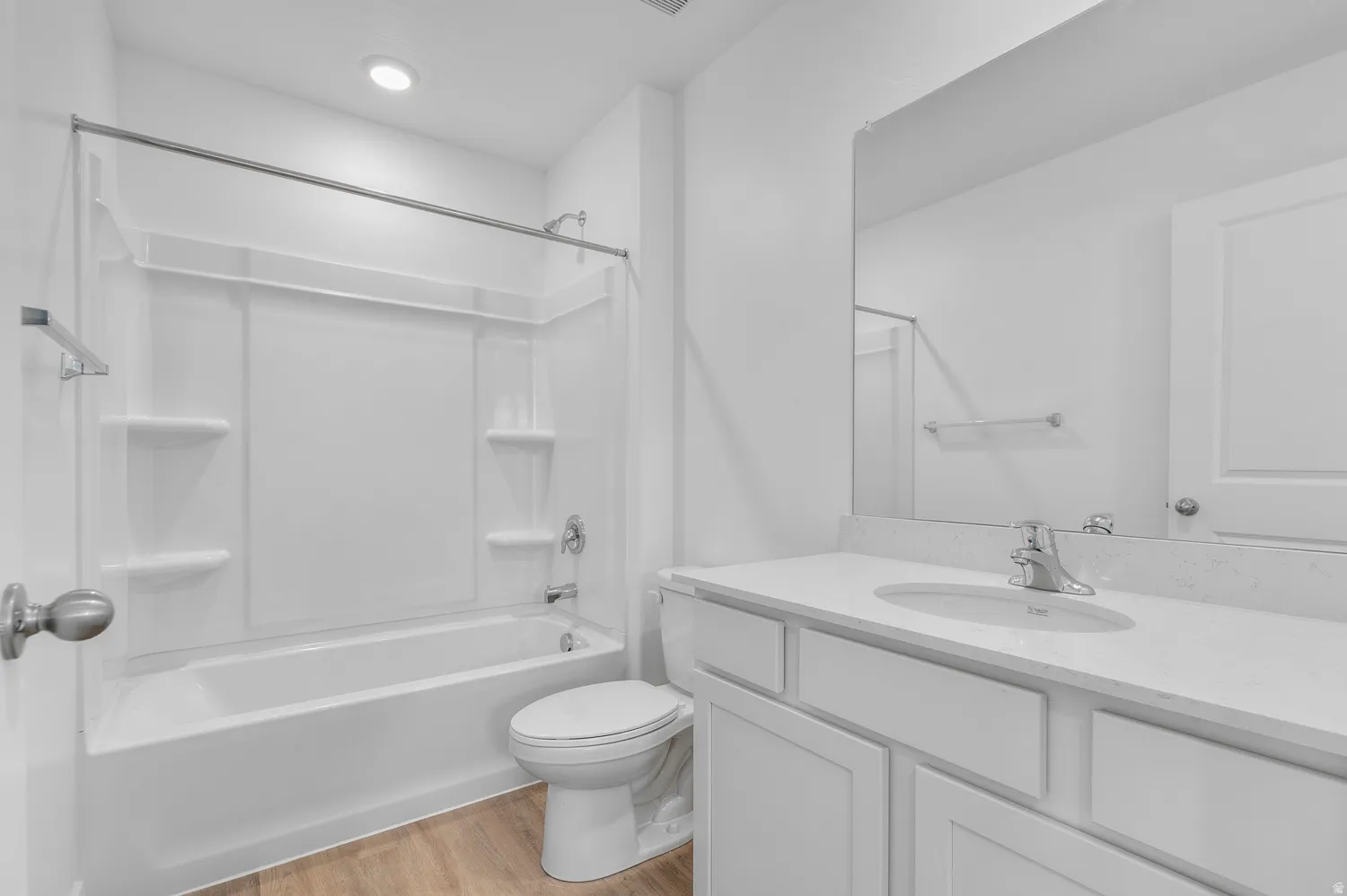 Bathroom with vanity, light wood-style flooring, and tub / shower combination