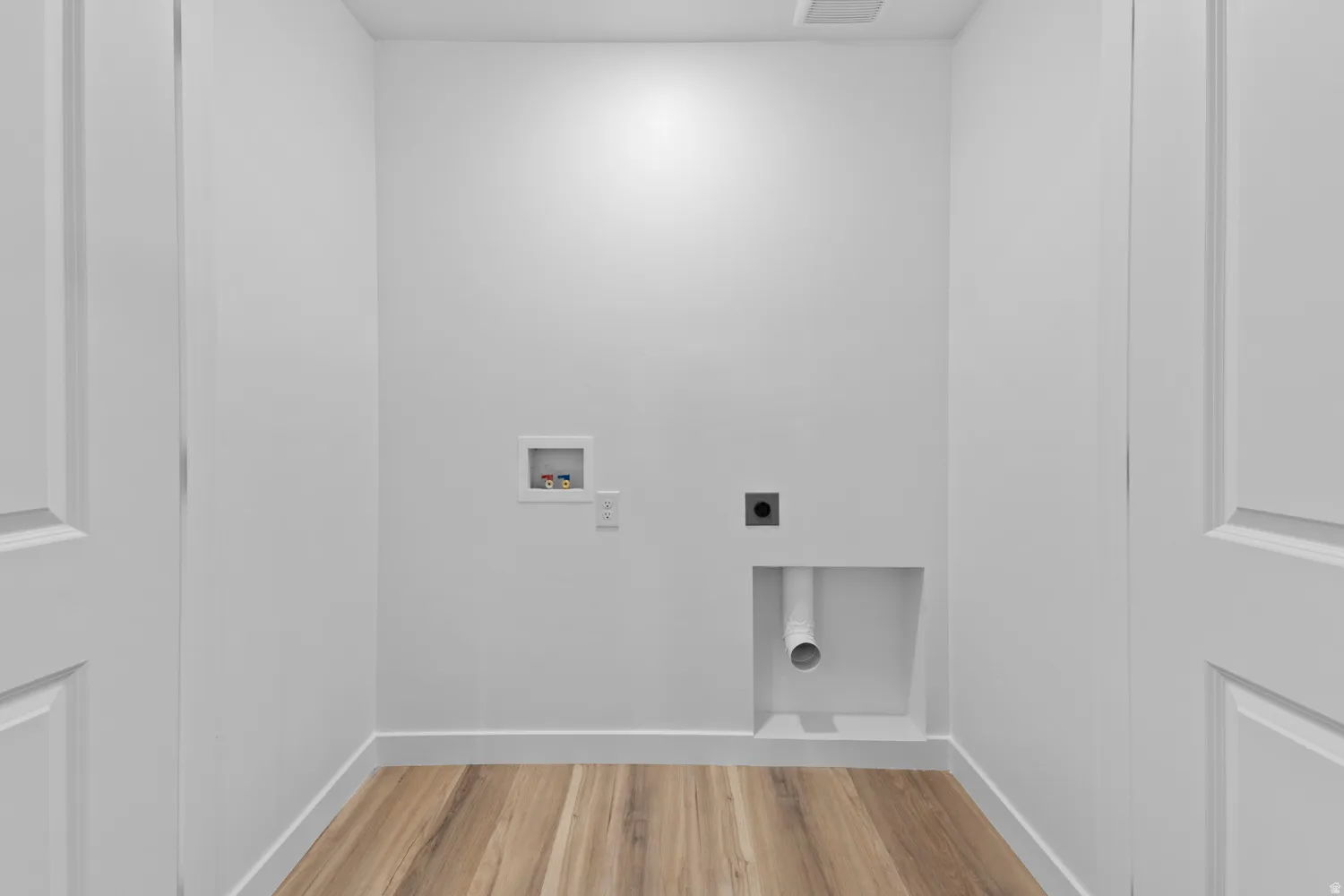 Laundry room with light wood finished floors, hookup for an electric dryer, and hookup for a washing machine