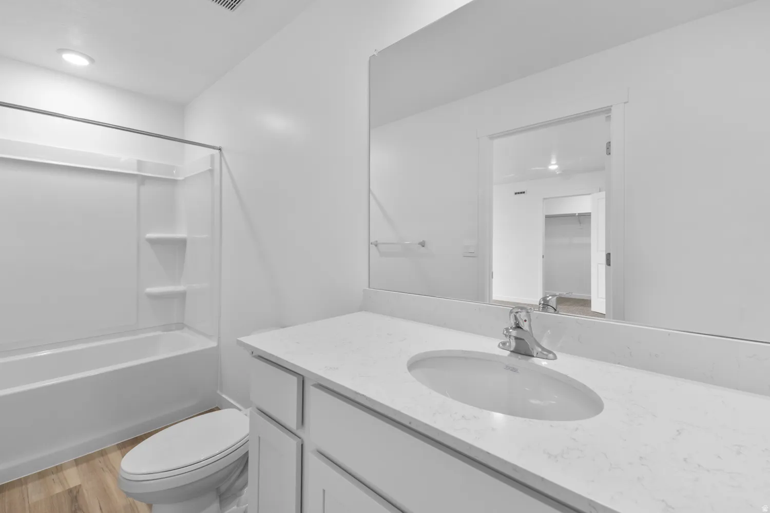 Full bathroom featuring vanity,  shower combination, and light wood-style floors