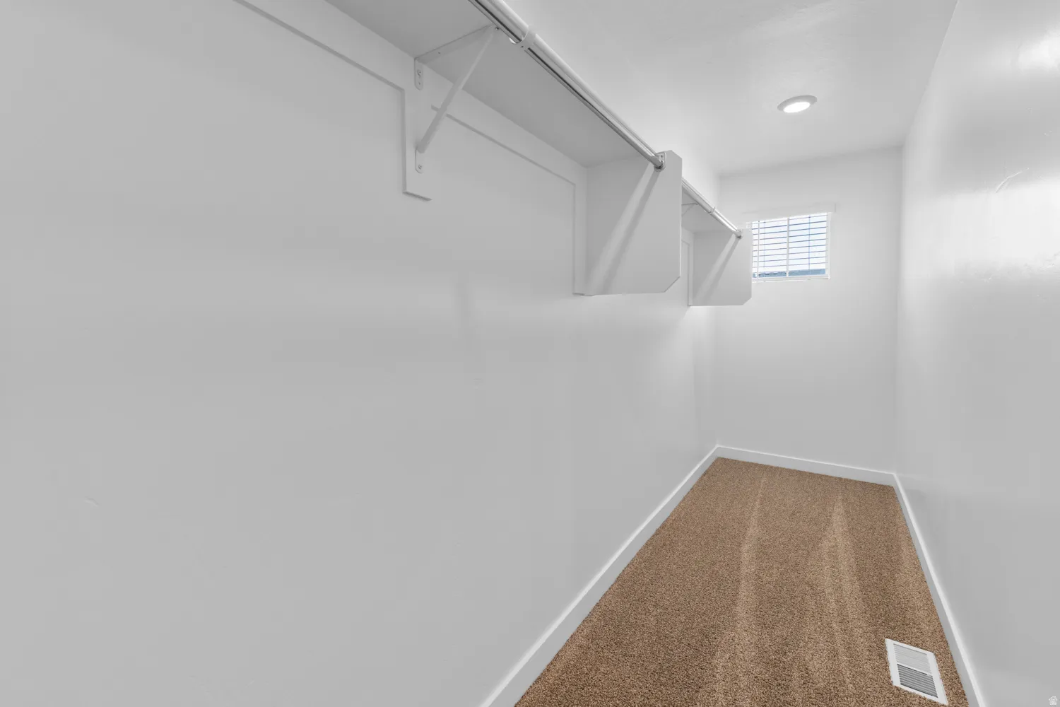 Walk in closet featuring carpet