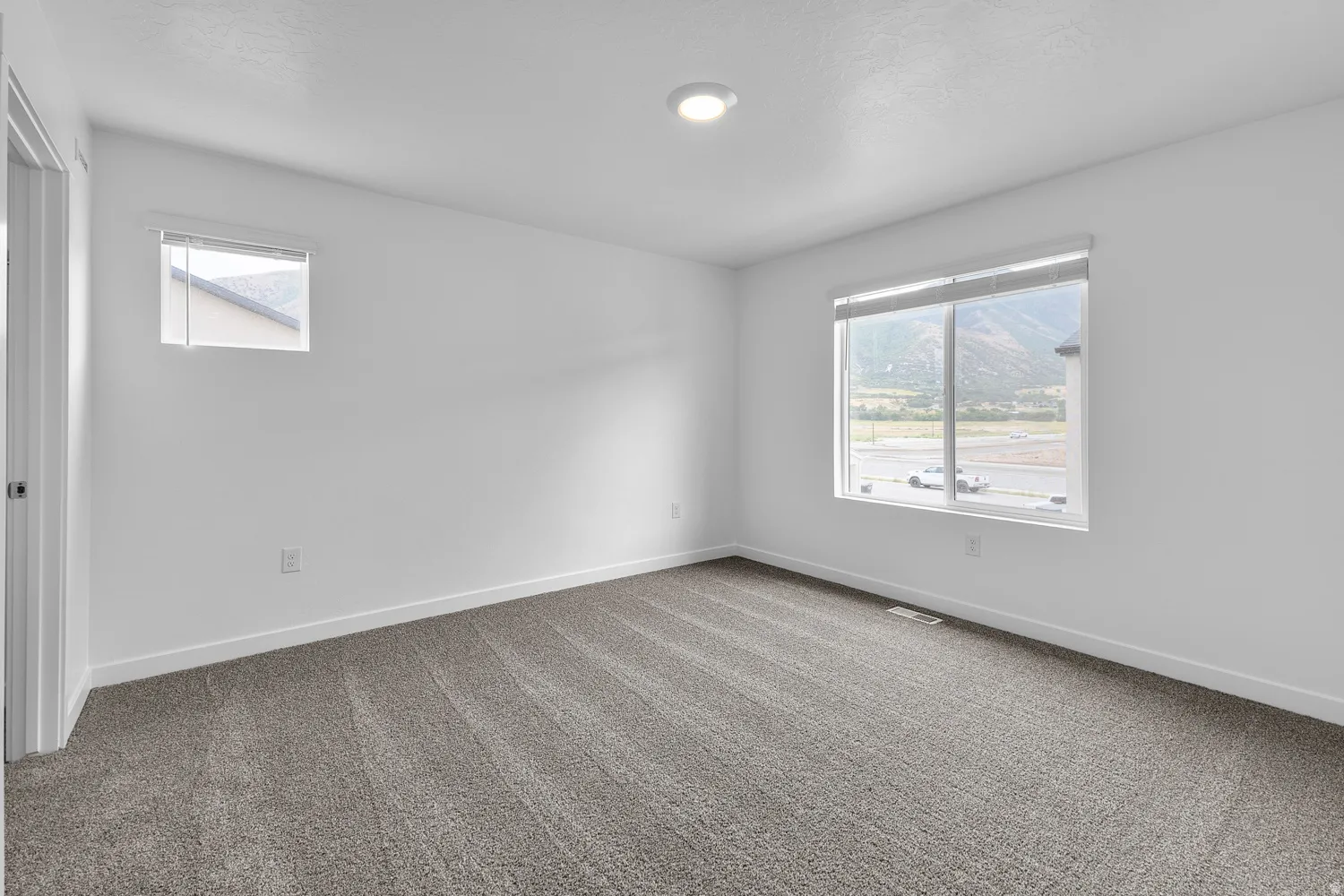Carpeted empty room featuring baseboards