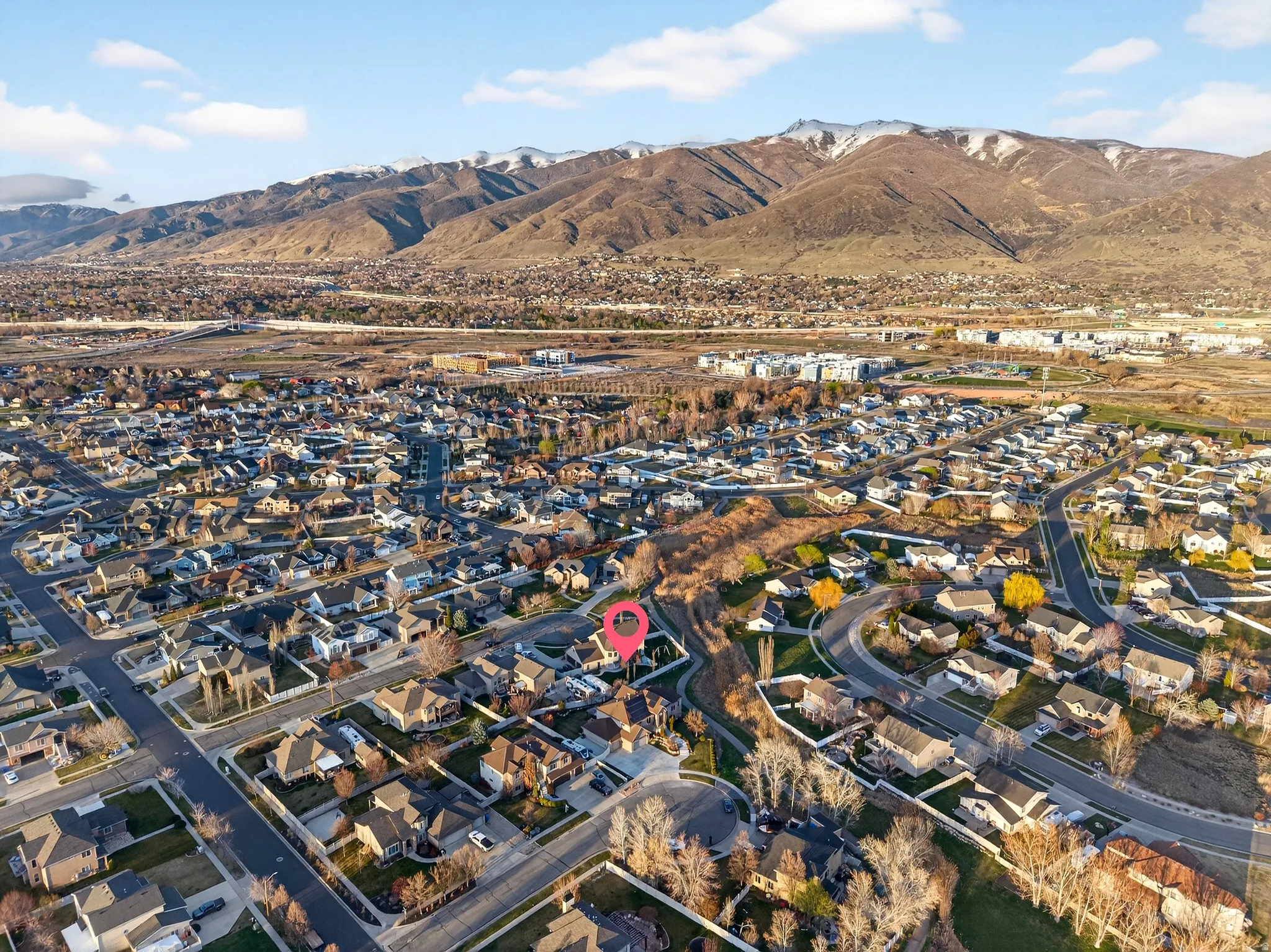 Aerial perspective of suburban area featuring a mountain backdrop