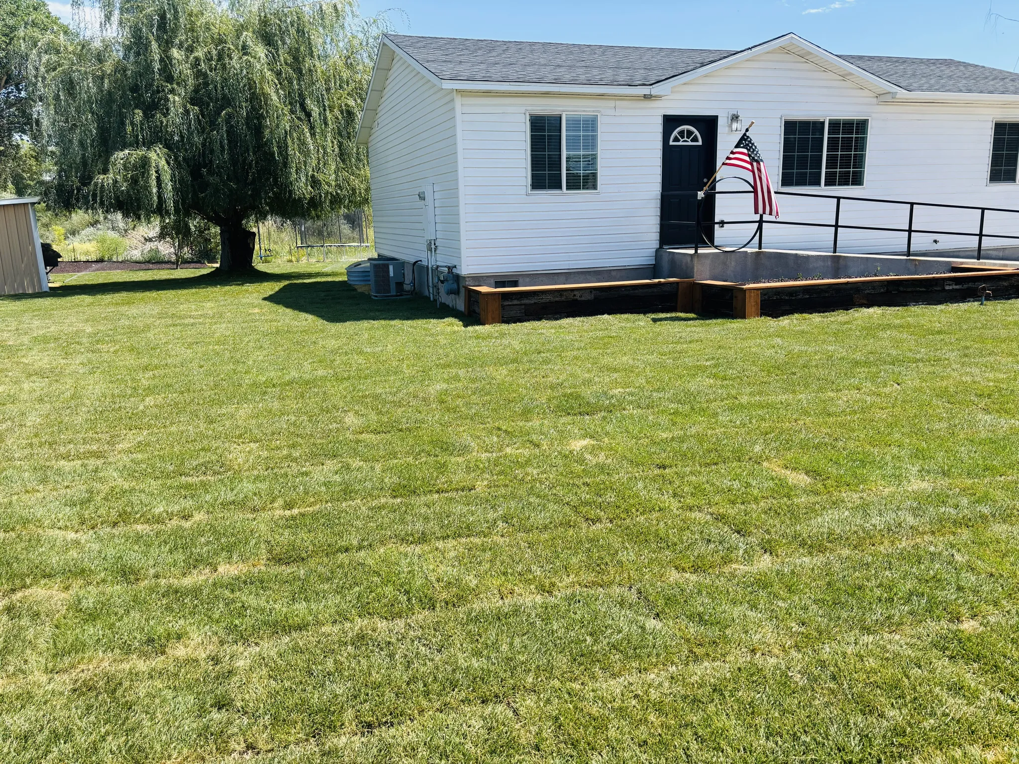 View of front facade with a front lawn, a shingled roof, and crawl space
