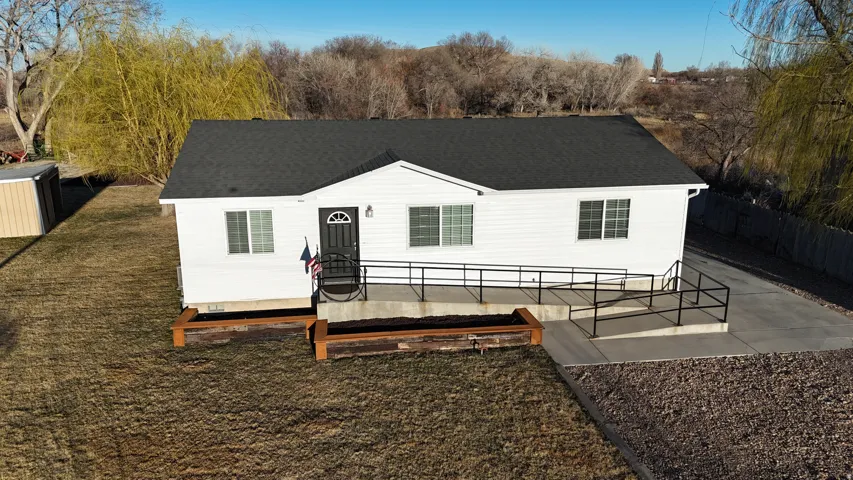 View of front of house with roof with shingles and a front yard