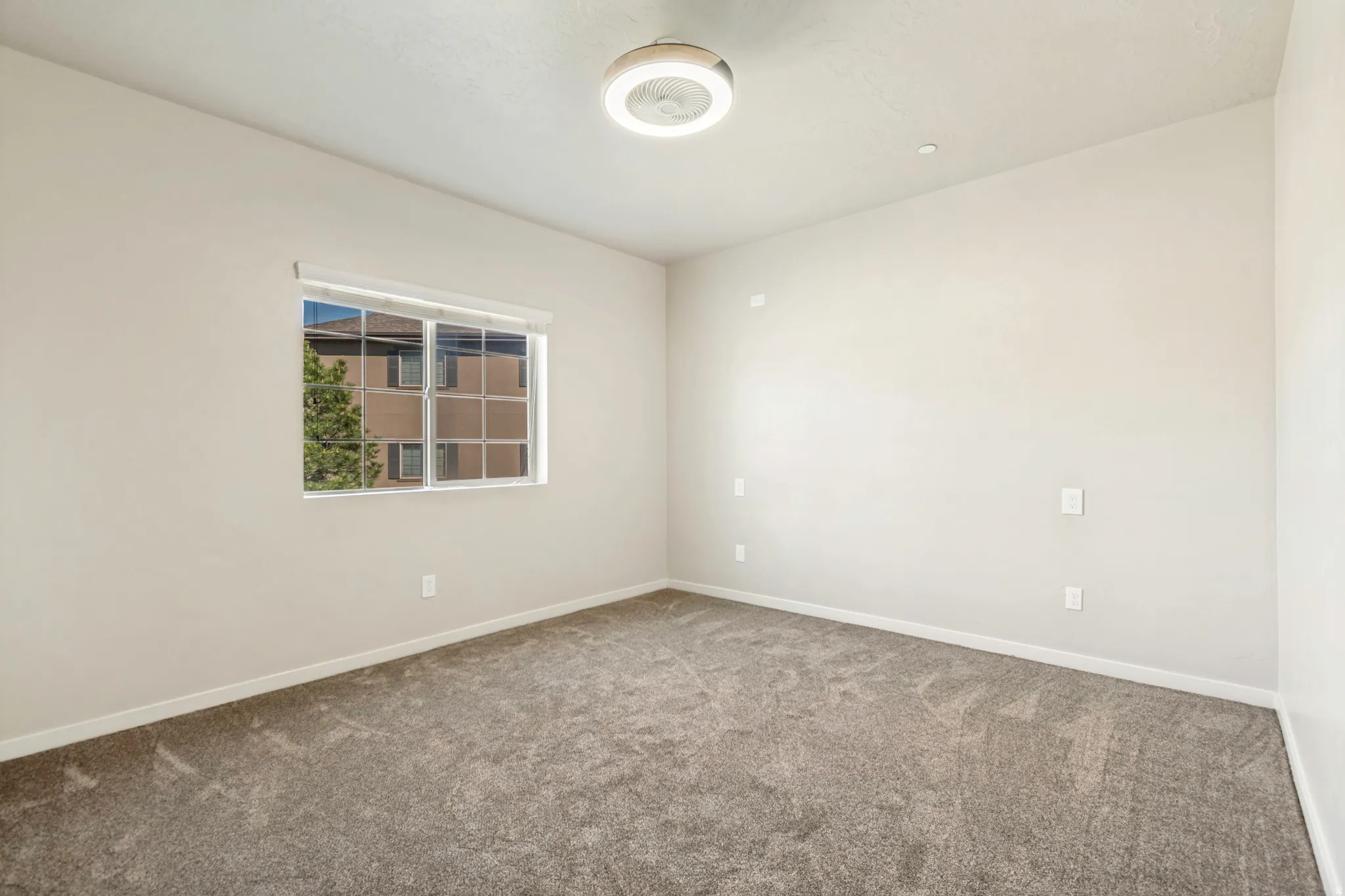 Neutral-toned walls and plush gray carpeting