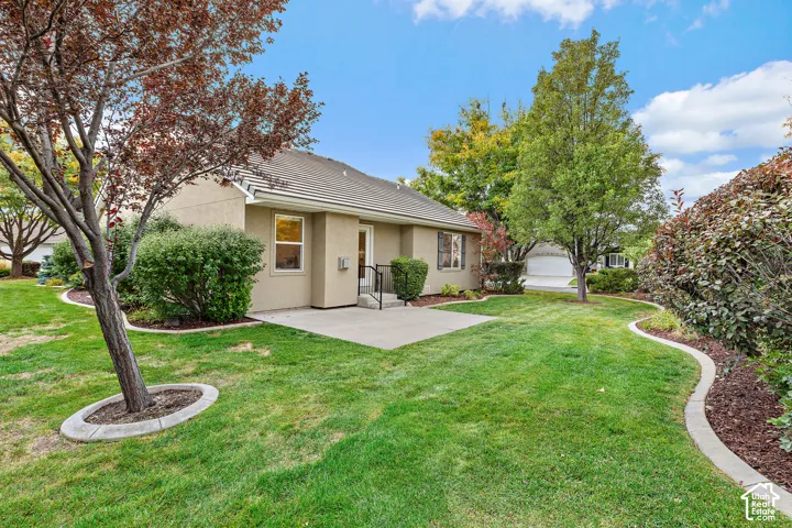 Expansive lawn area with mature trees and established landscaping