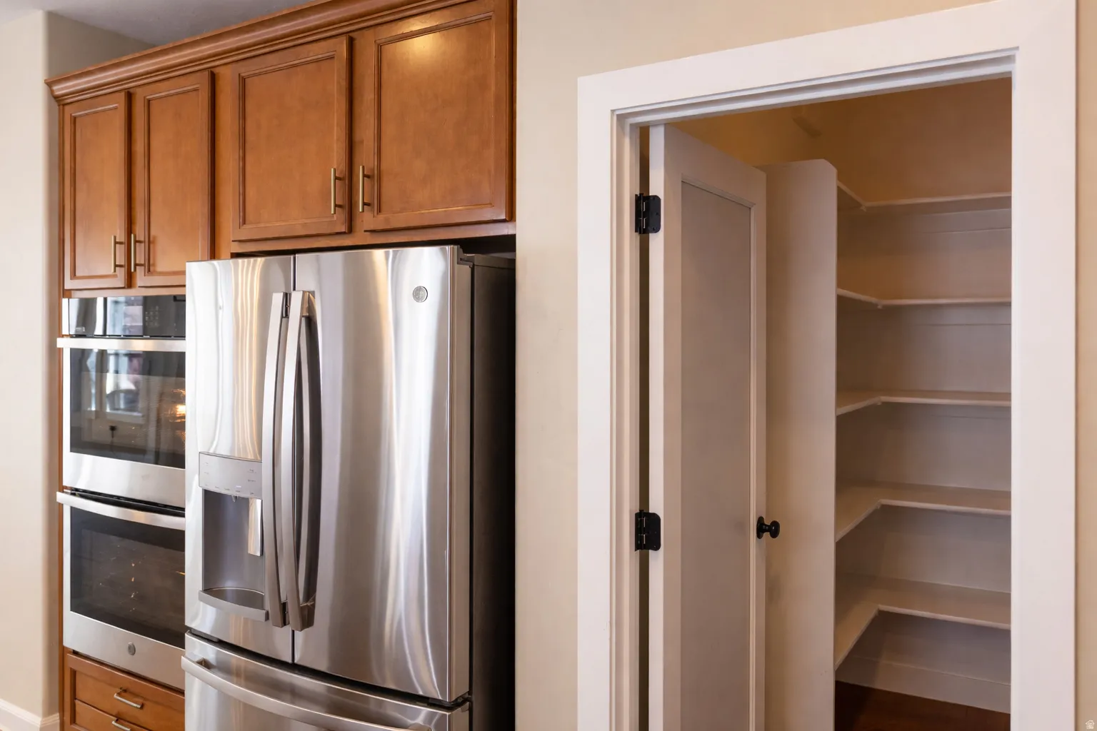 Kitchen with stainless steel appliances and wood finish cabinetry