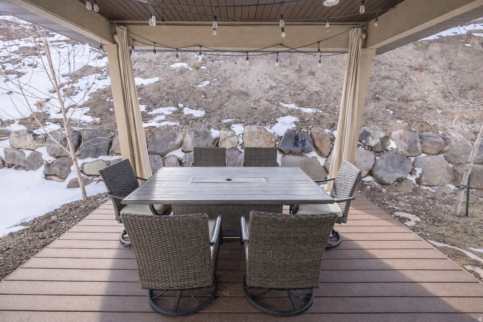 Snow covered deck with outdoor dining area