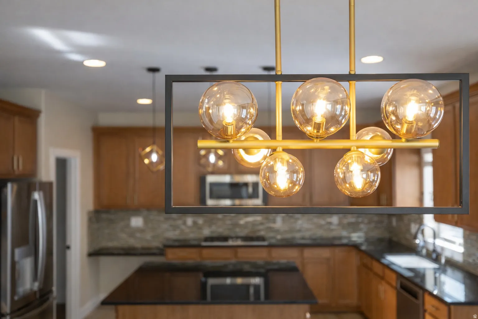Kitchen with stainless steel appliances, a center island, wood finish cabinetry, and decorative backsplash