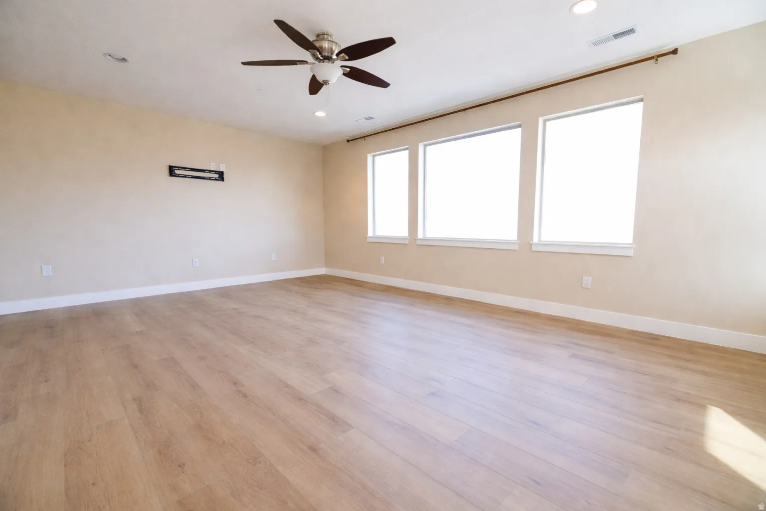 Spare room featuring recessed lighting, ceiling fan, and light wood-type flooring