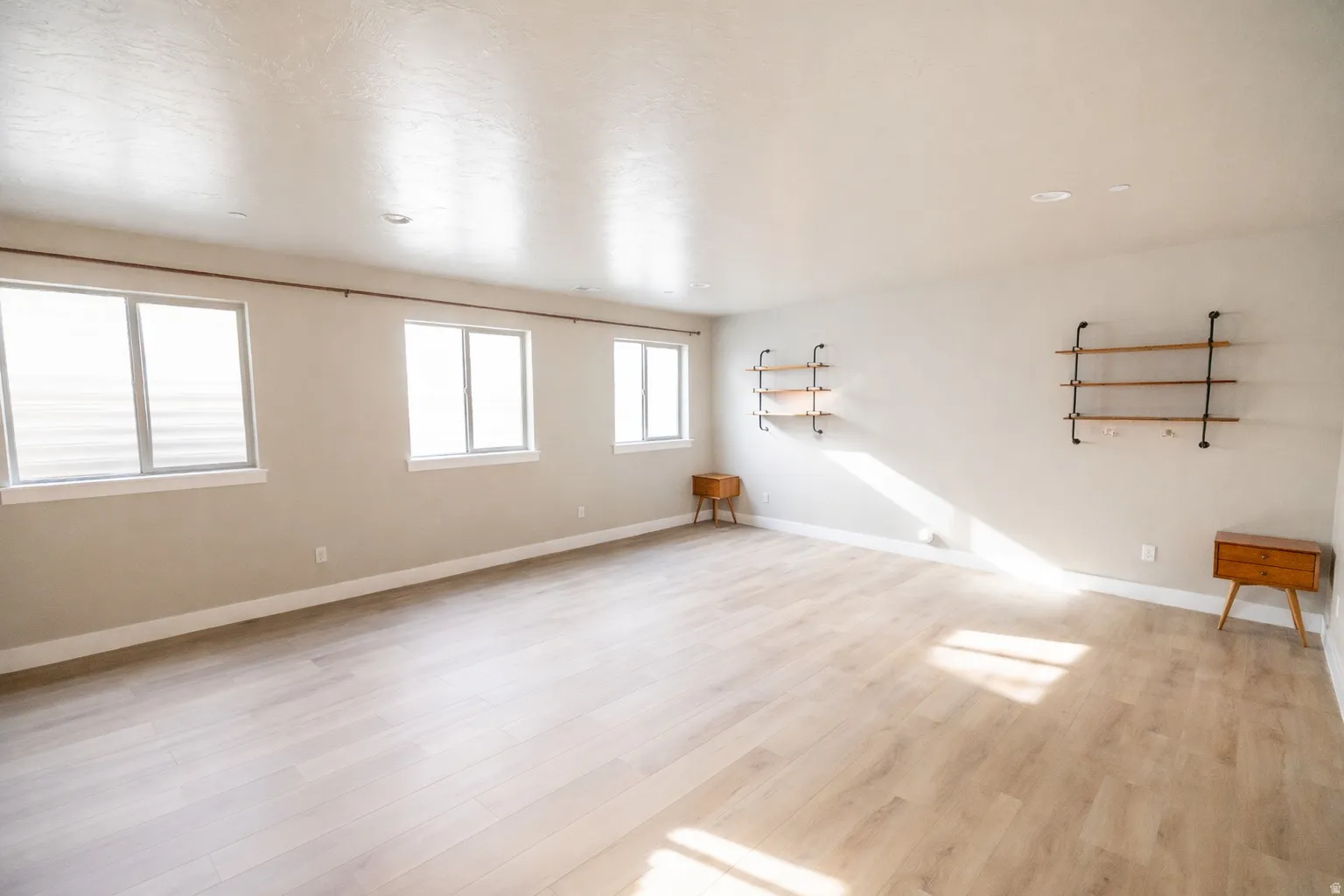Unfurnished room featuring baseboards and light wood finished floors