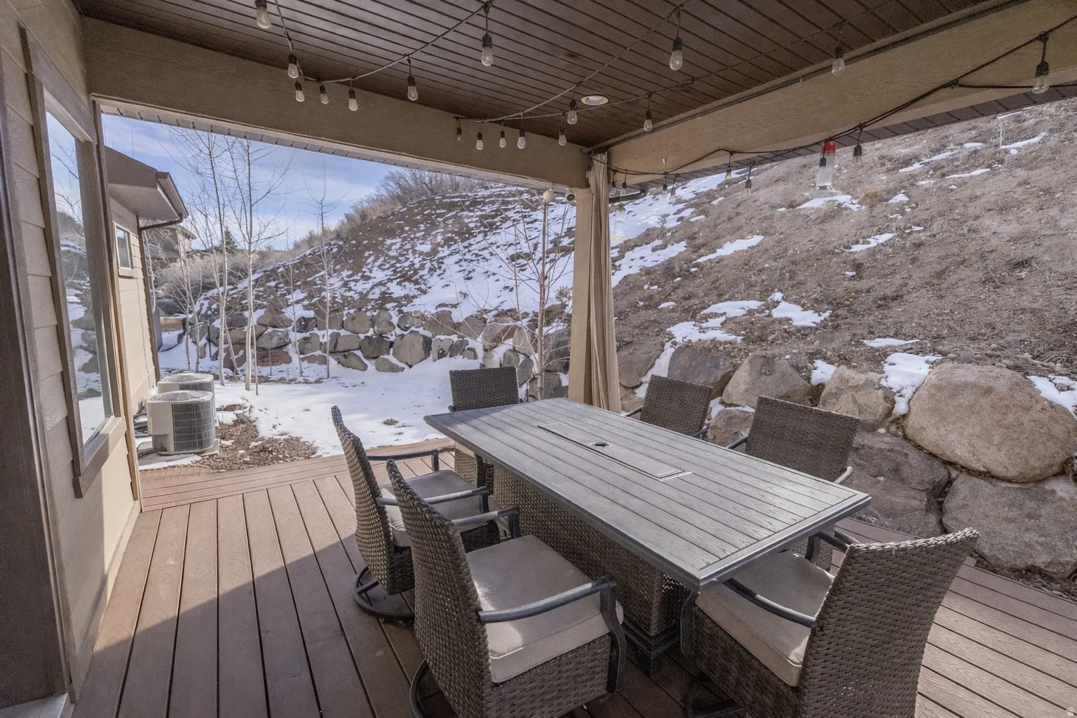 Snow covered deck featuring outdoor dining space