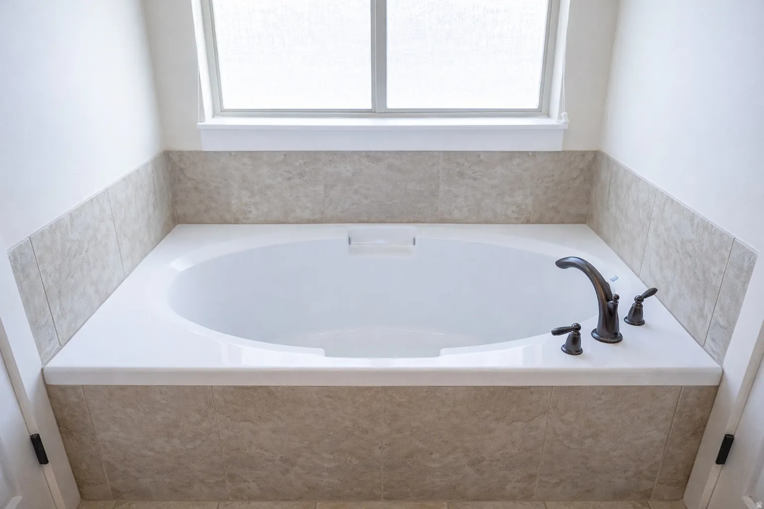 Full bath with plenty of natural light and a bath