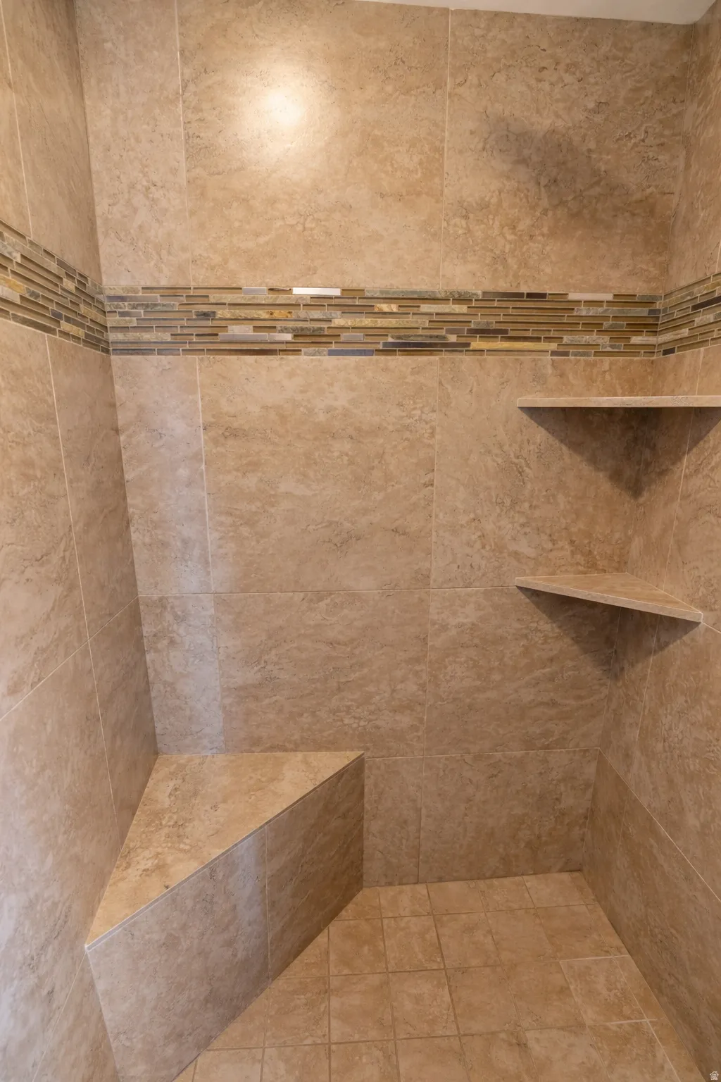 Full bath featuring tiled shower