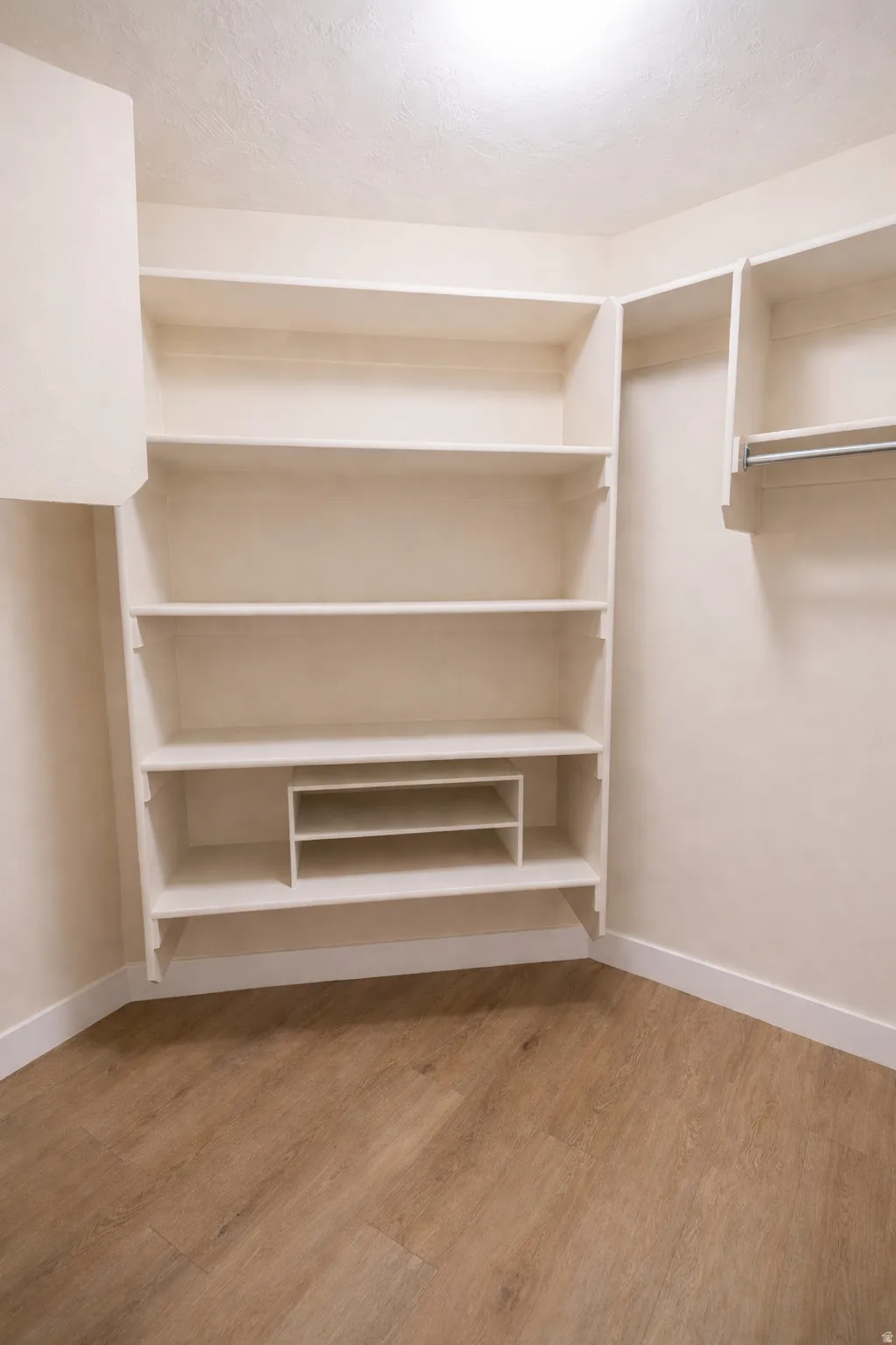 Walk in closet featuring light wood finished floors
