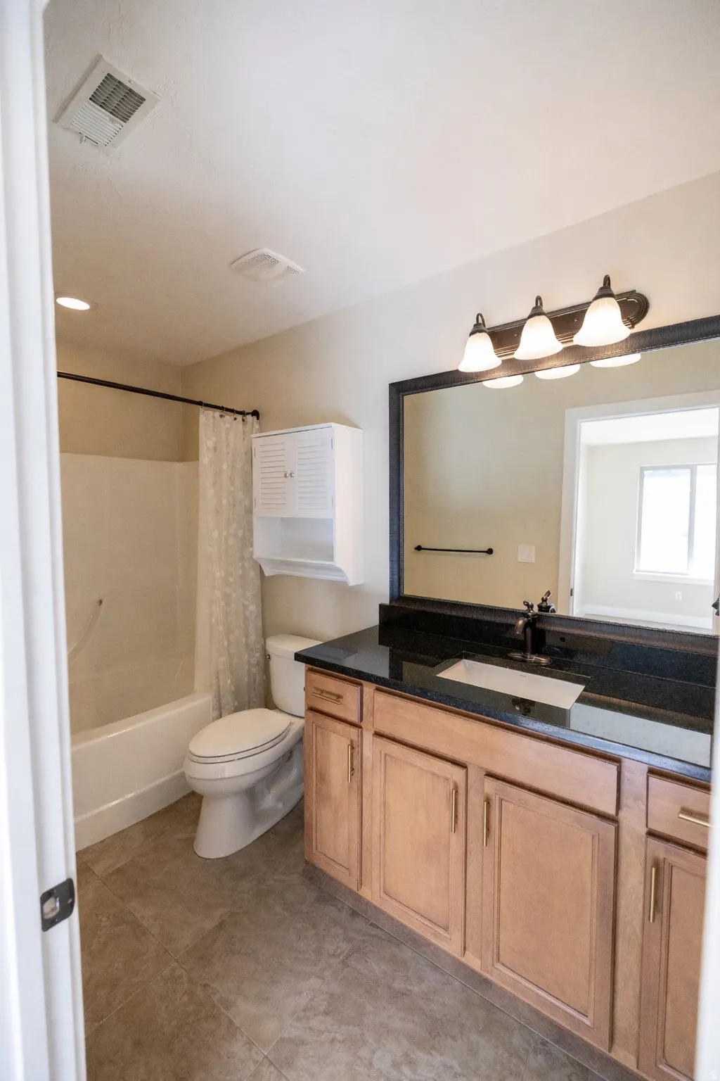 Full bathroom with vanity and shower / tub combo