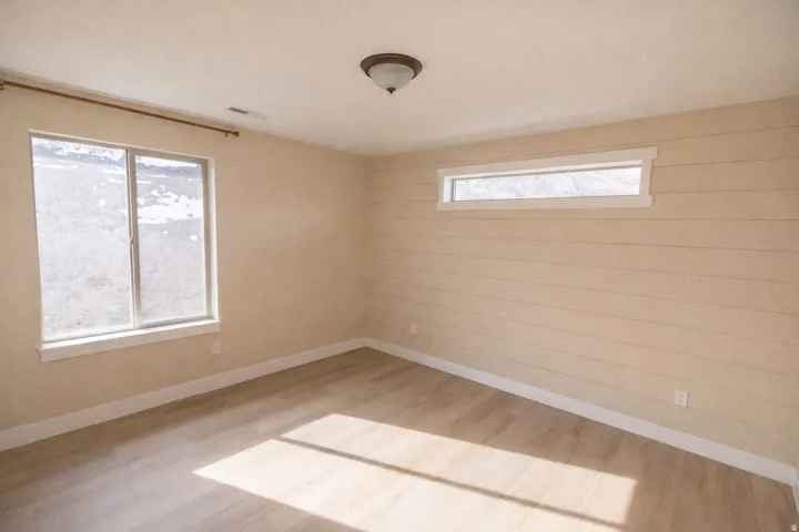 Spare room with light wood-type flooring and baseboards