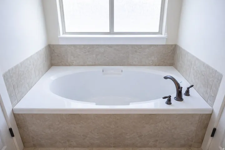 Full bath with plenty of natural light and a bath