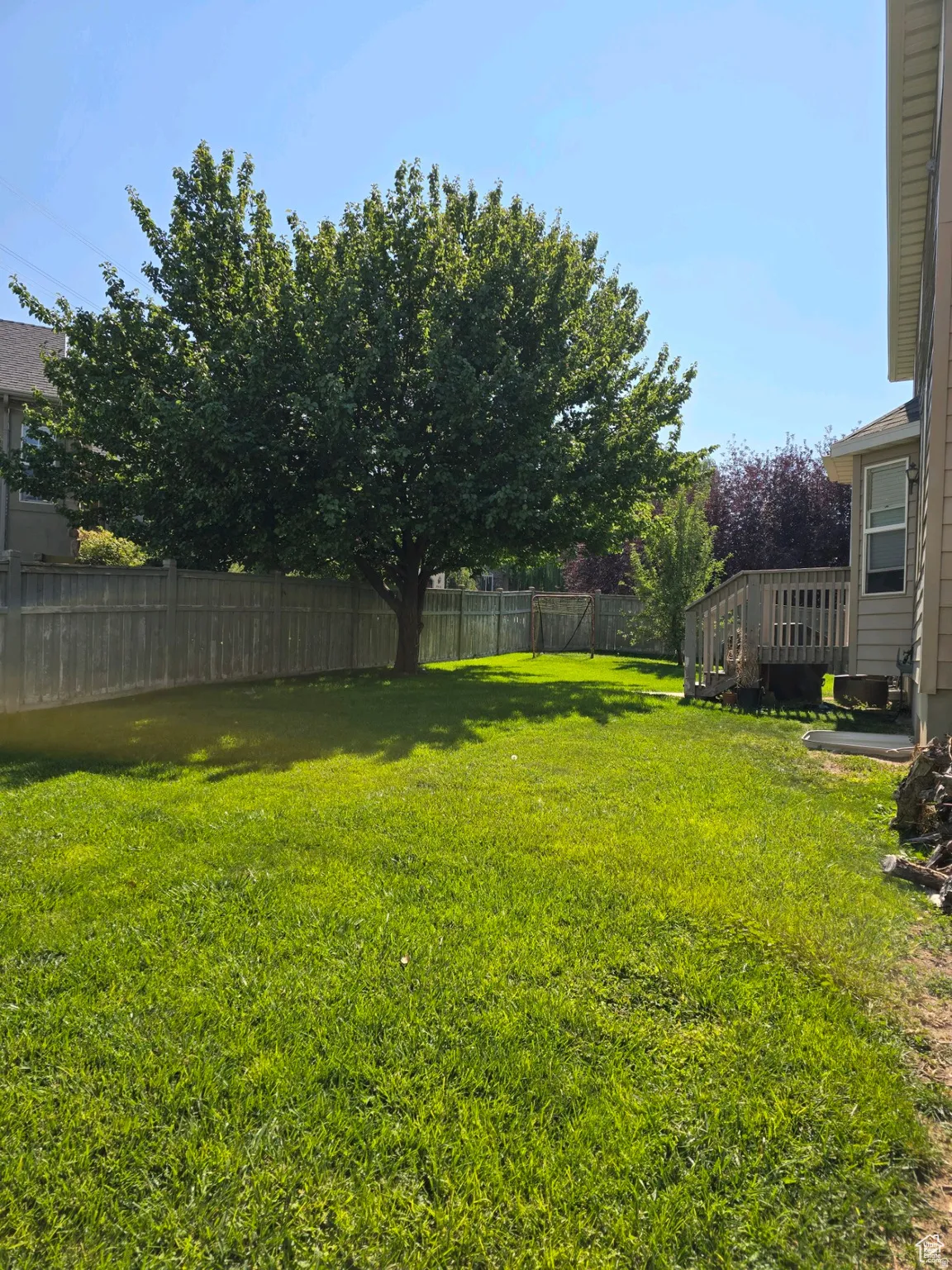 Fenced backyard featuring a wooden deck