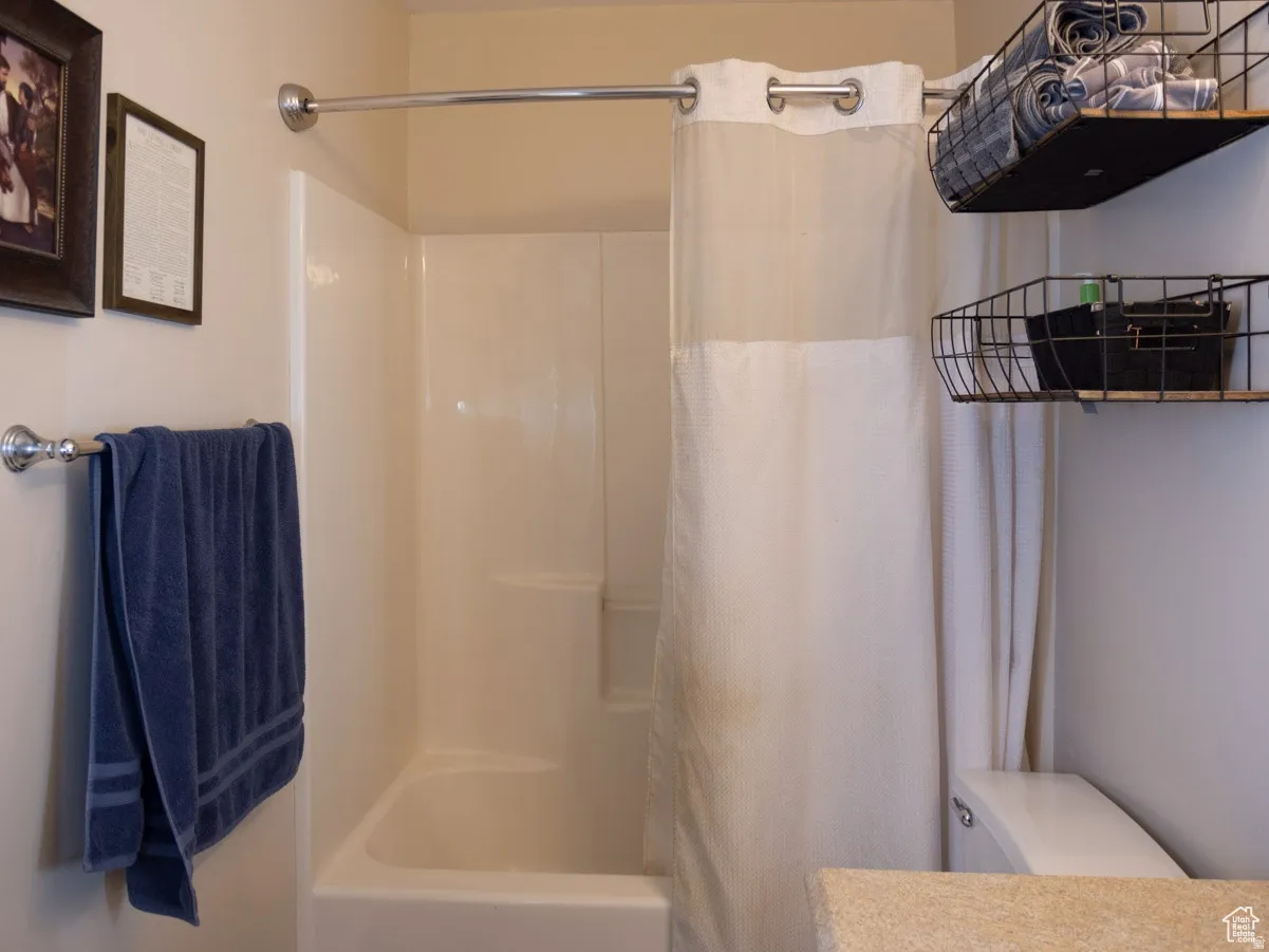 Full bath featuring shower / tub combo and vanity