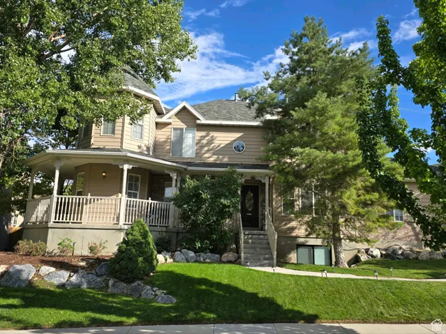 View of front facade charming design with mature trees and lots of character