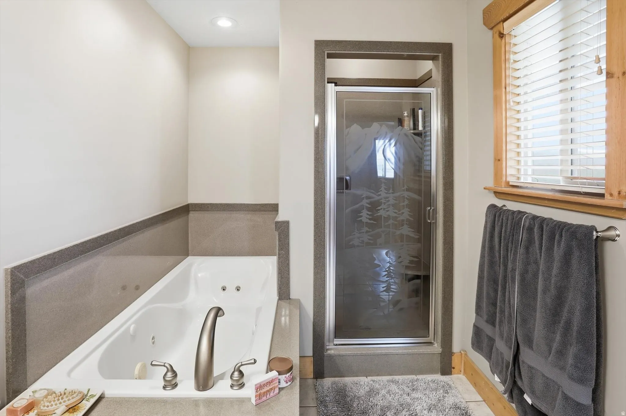 Primaryl bathroom  ensuite with a tub with jets and a stall shower