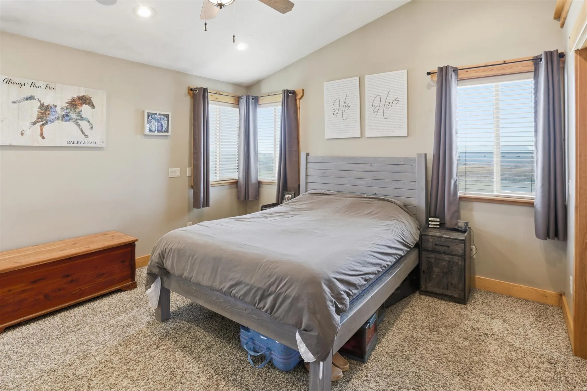 Primary Bedroom with lofted ceiling, light colored carpet, ceiling fan, and recessed lighting
