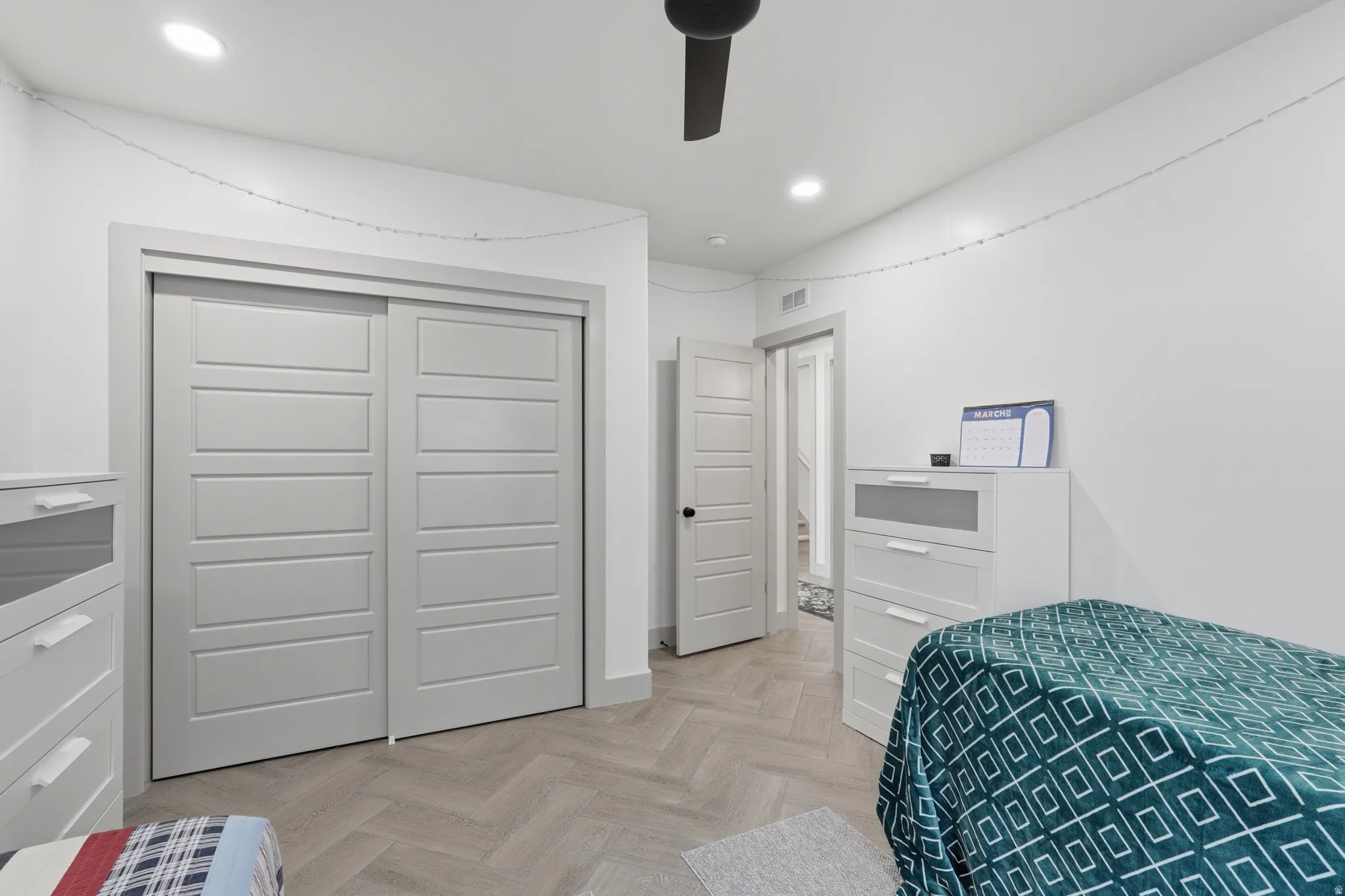 Bedroom featuring a closet, parquet flooring, recessed lighting, and a ceiling fan