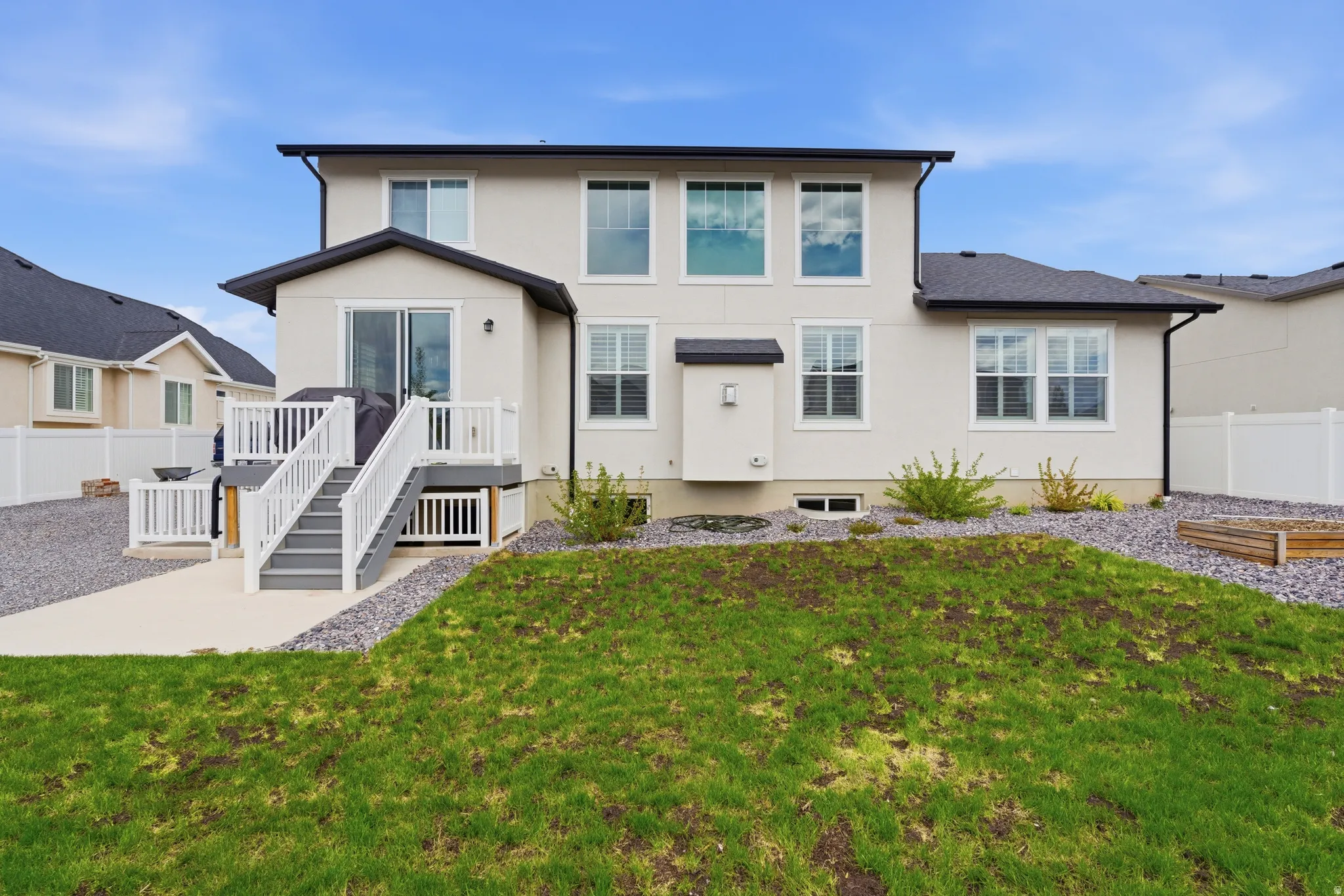 Rear view of property with stucco siding and a patio