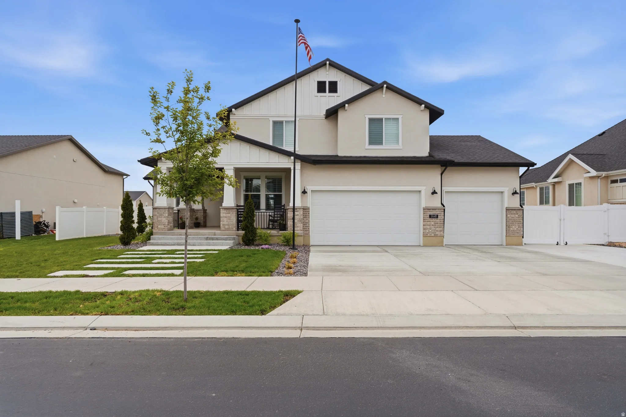 Craftsman inspired home featuring covered porch, driveway, stucco siding, and a garage